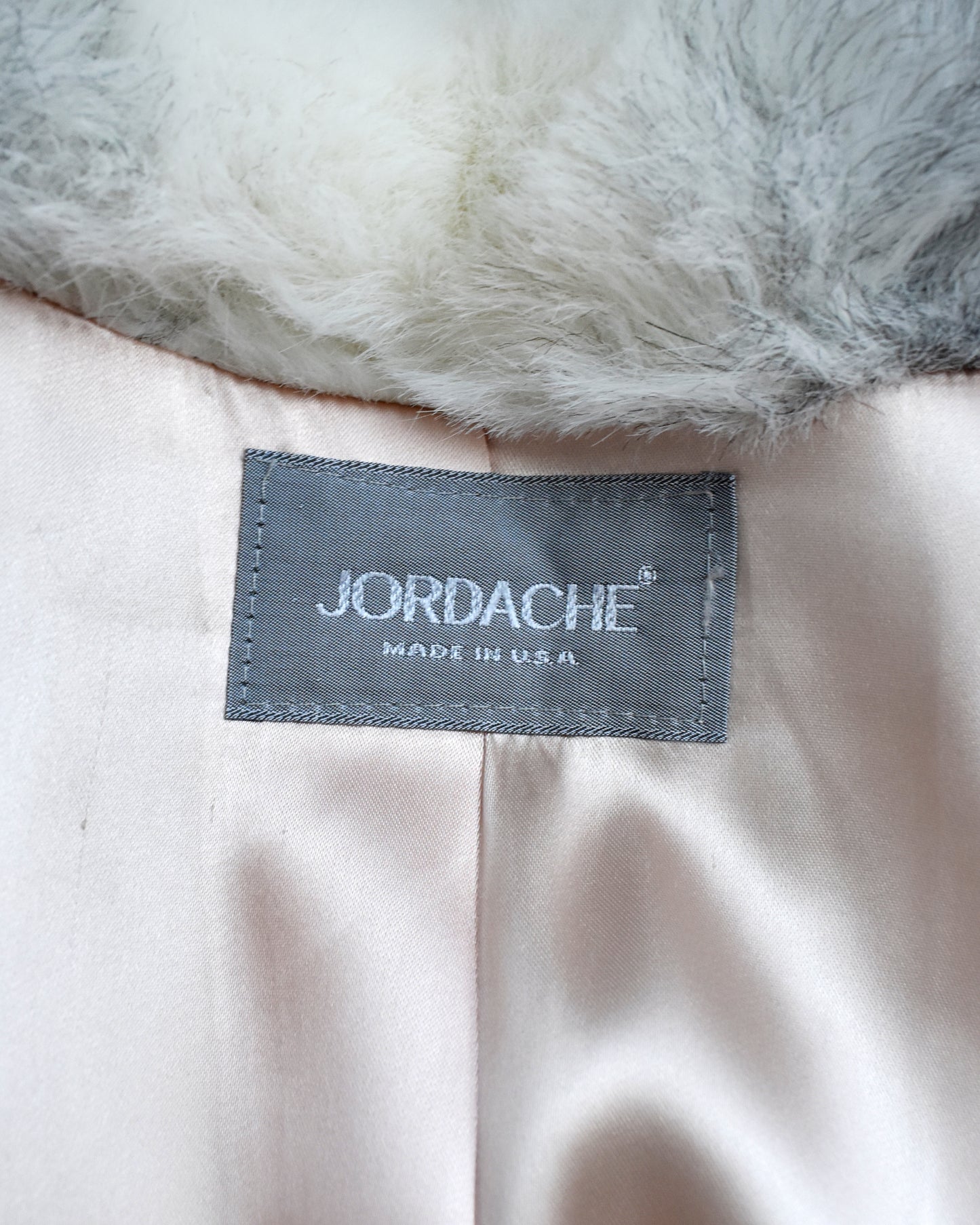 Jordache label on a pink fabric background