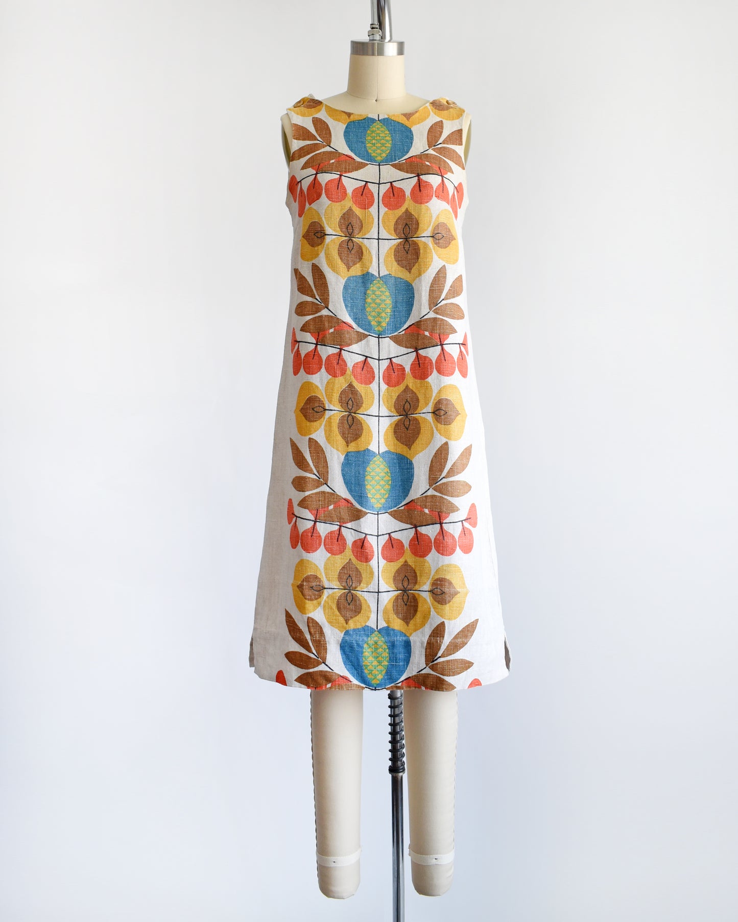 a vintage 1960s shift dress with a colorful mid century floral print on the front and back.