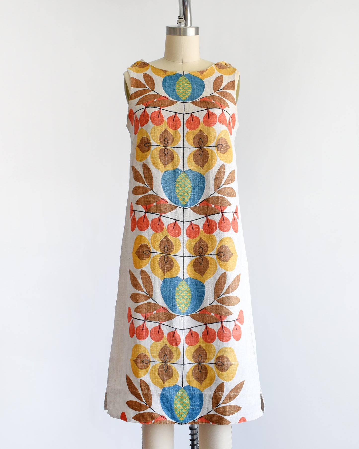 a vintage 1960s shift dress with a colorful mid century floral print on the front and back.