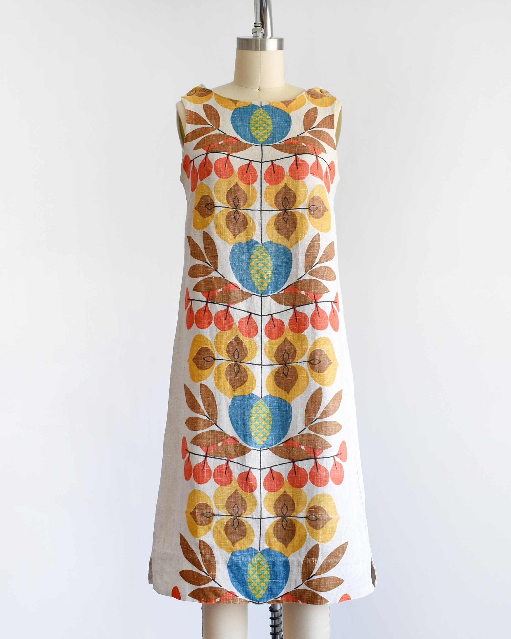 a vintage 1960s shift dress with a colorful mid century floral print on the front and back.