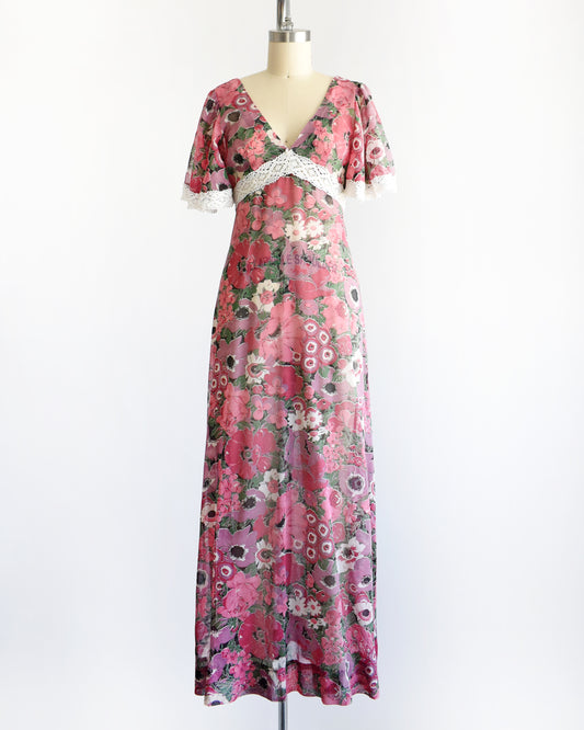 a vintage 1970s floral dress on a mannequin against a white background
