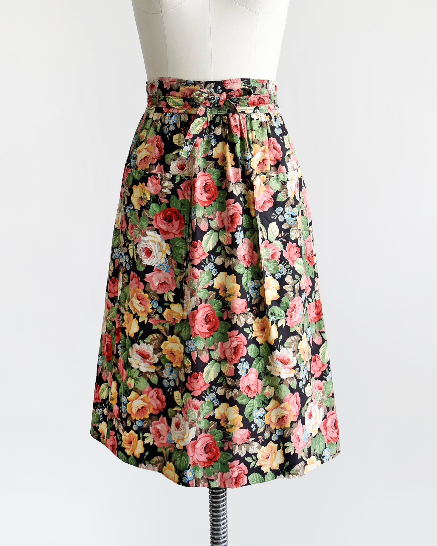 a vintage 1970s black floral wrap skirt that has two large pockets on the front