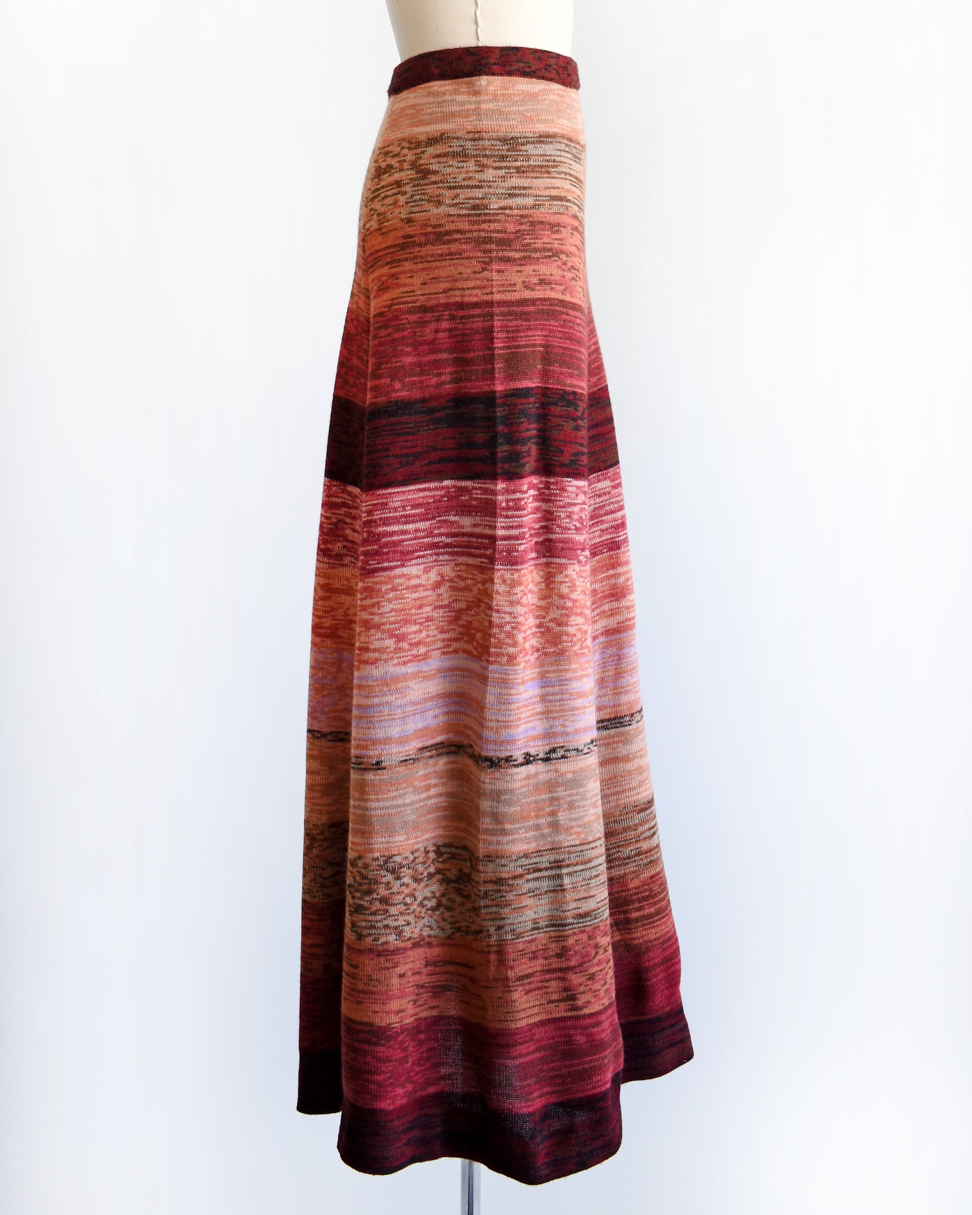 side view of a vintage 1970s striped space dye maxi skirt on a mannequin against a white background