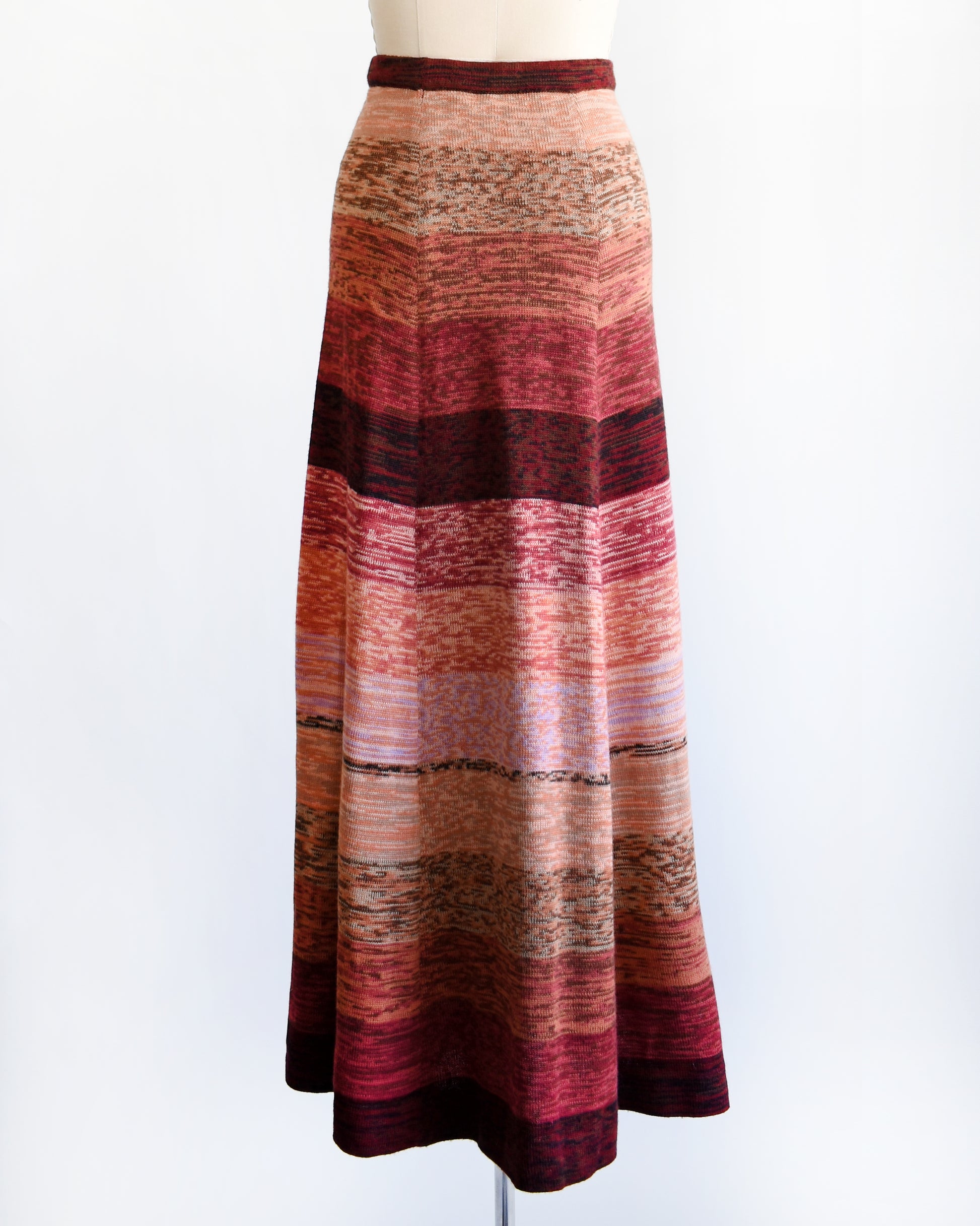 back view of a vintage 1970s striped space dye maxi skirt on a mannequin against a white background