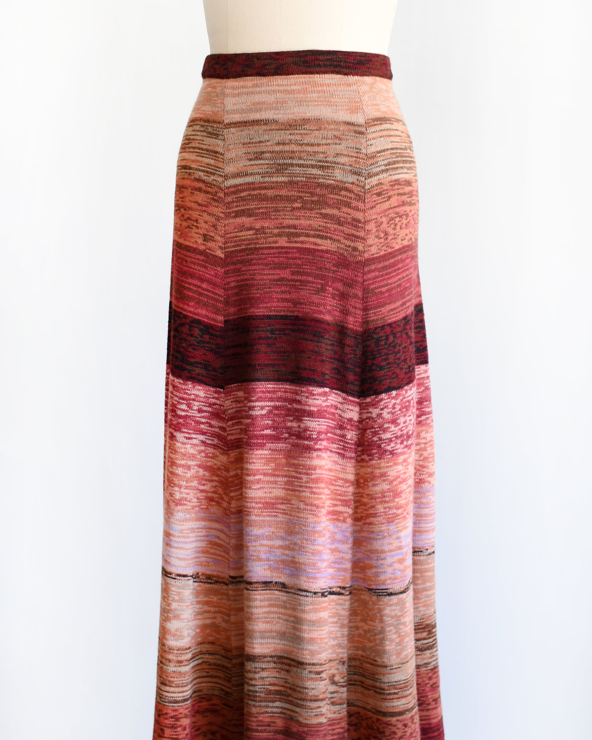 side front view of a vintage 1970s striped space dye maxi skirt on a mannequin against a white background
