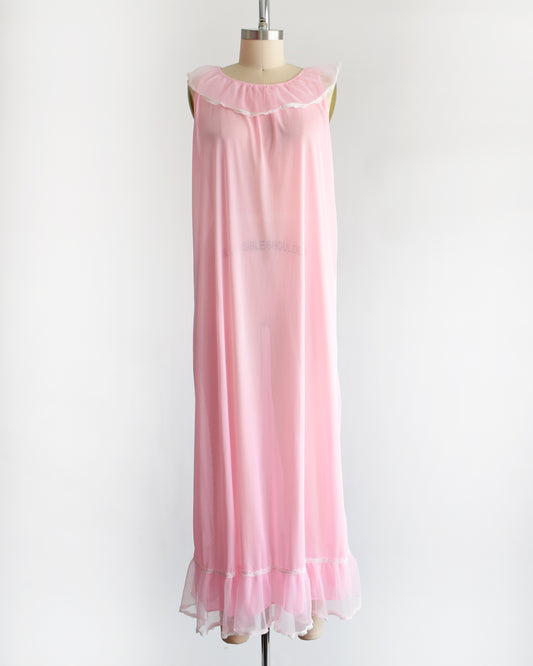 a vintage 1970s sleeveless pink nightgown with a ruffled collar and hem, displayed on a dress form against a plain white background.