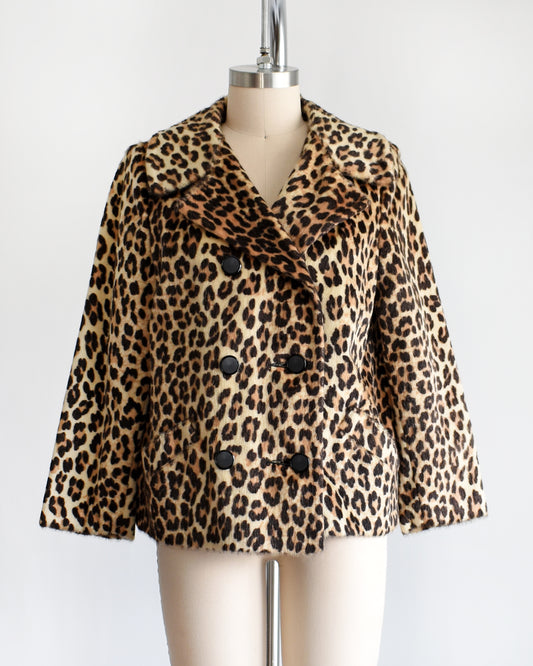 a vintage 1960s leopard print jacket on a mannequin against a white background
