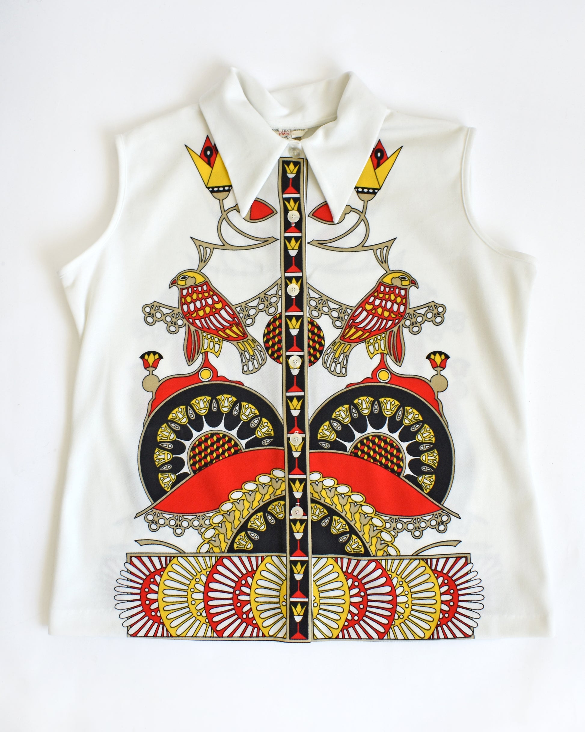 a vintage 1970s white sleeveless top with a colorful abstract bird design on a white background

