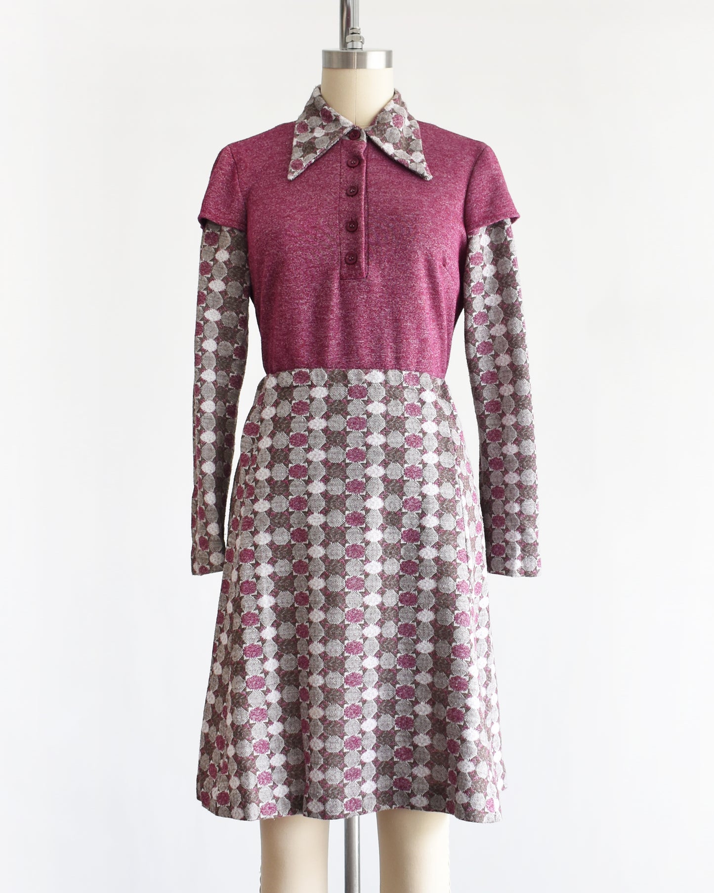 a vintage 1970s dress set that has a purple top and patterned skirt on a mannequin against a white background