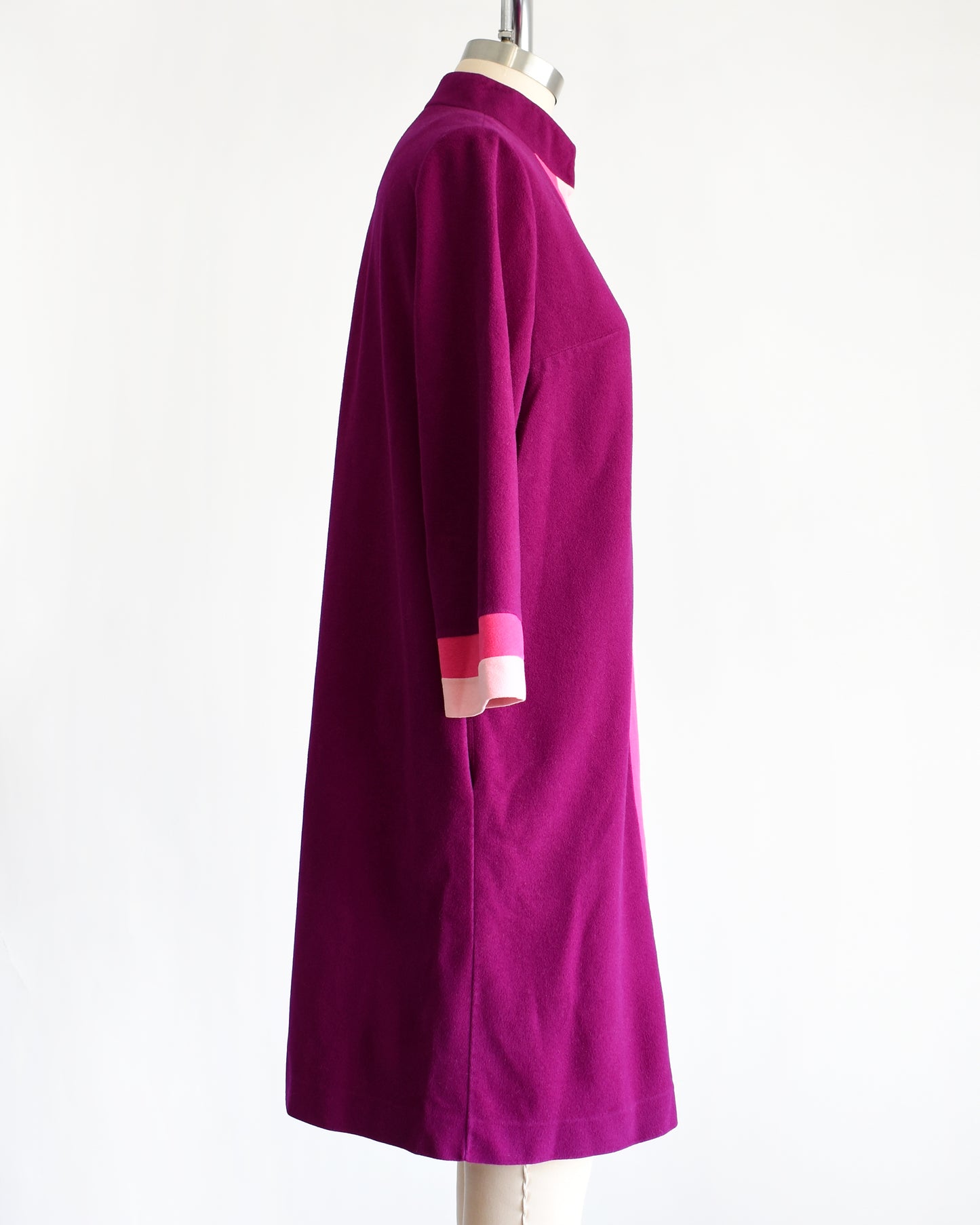 side view of a vintage 1970s deep magenta and pink Vanity Fair robe on a mannequin against a white background