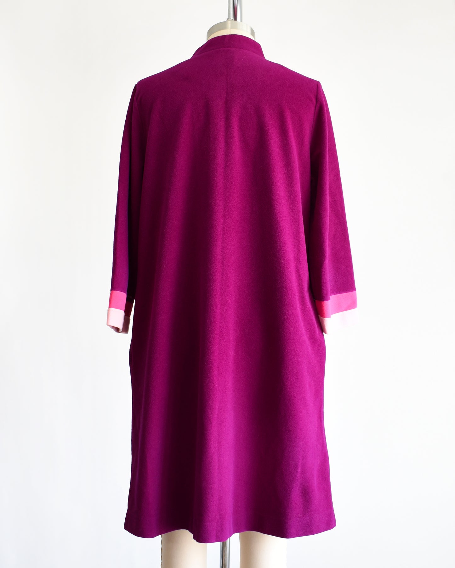 back view of a vintage 1970s deep magenta and pink Vanity Fair robe on a mannequin against a white background