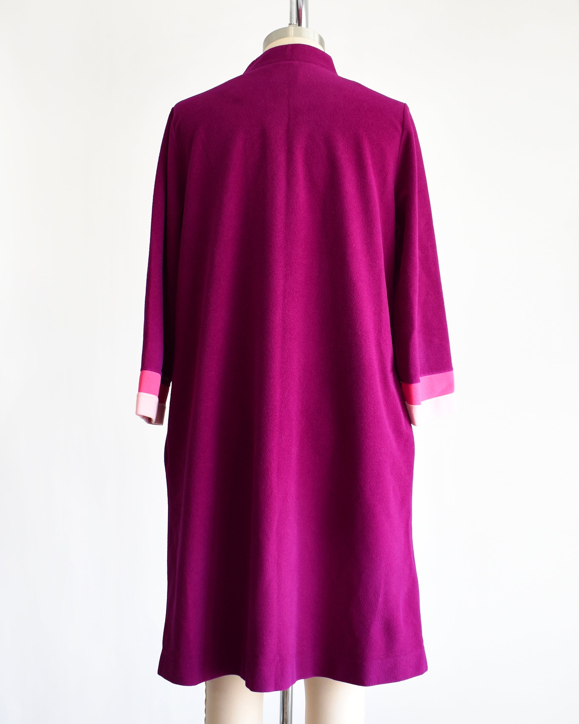 back view of a vintage 1970s deep magenta and pink Vanity Fair robe on a mannequin against a white background
