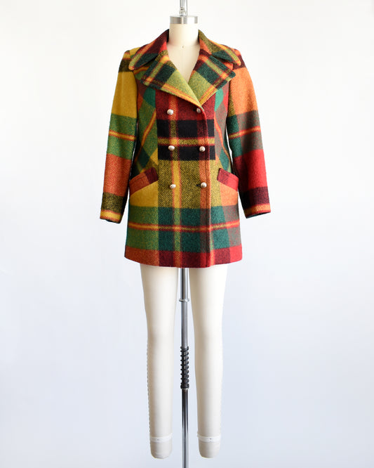 a vintage 1970s rainbow plaid coat on a mannequin against a white background
