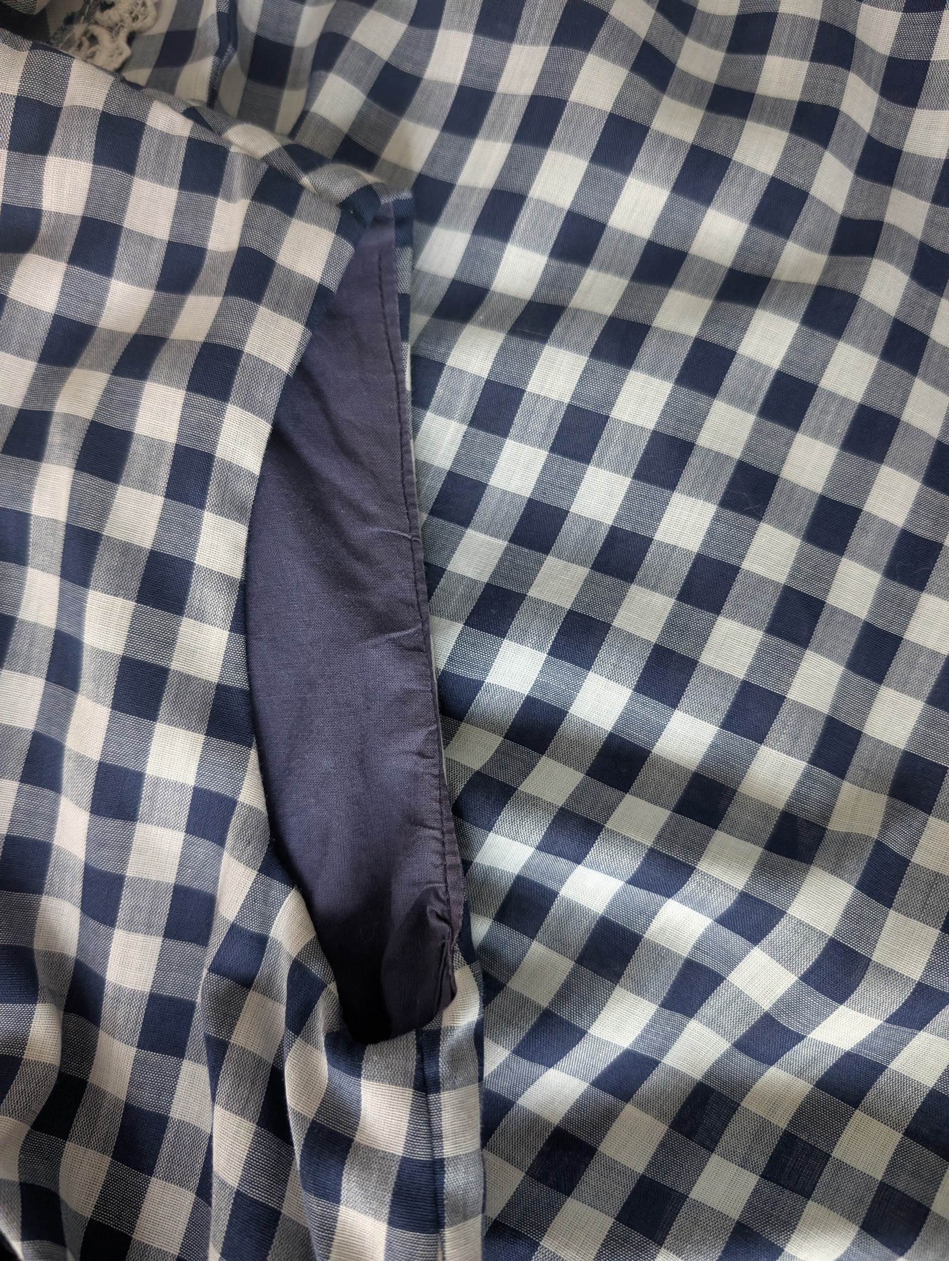Close-up of the dark navy blue inner lining of the arm opening