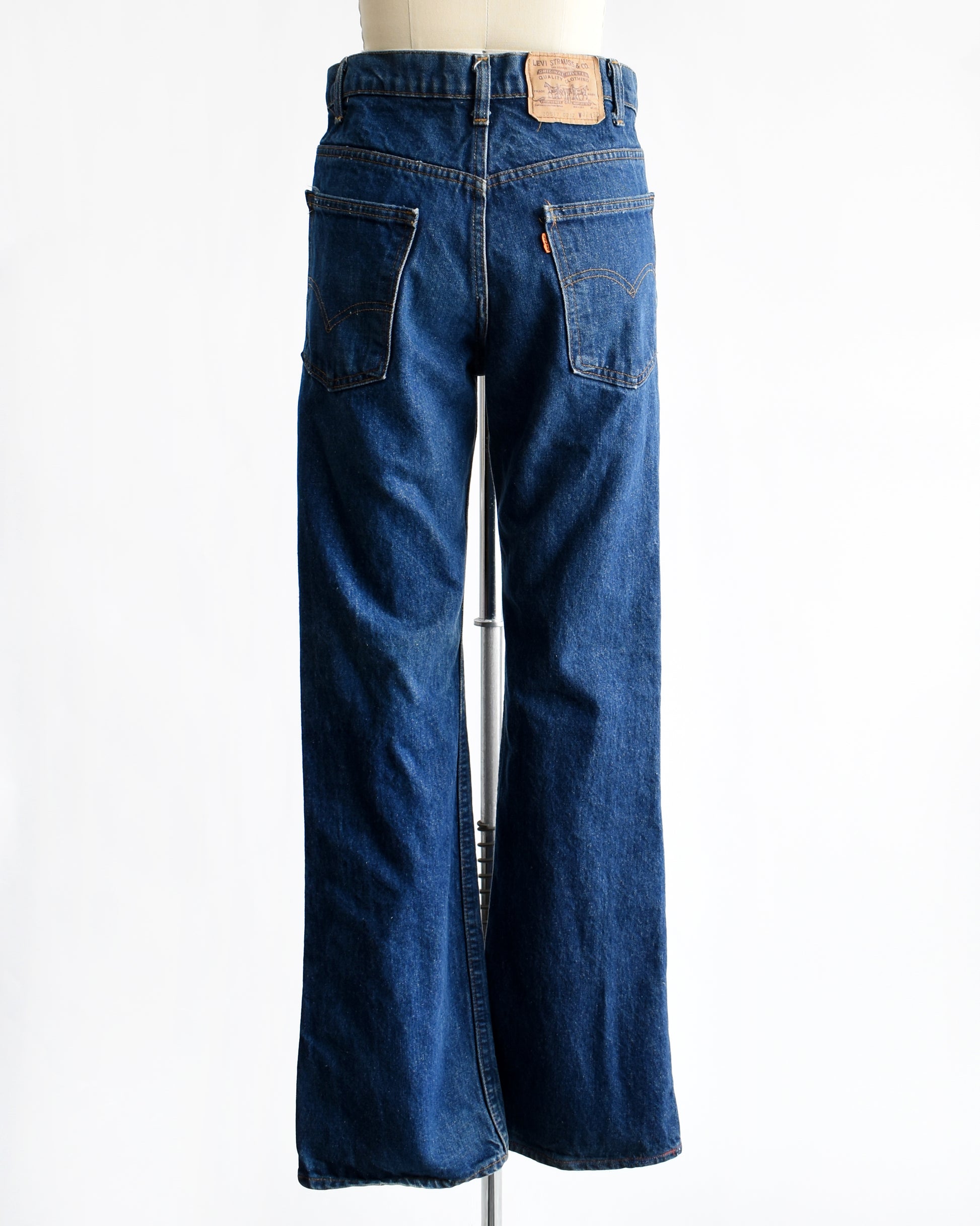 back view of vintage 1980s orange tab book cut 517 Lev's on a mannequin on a dress form