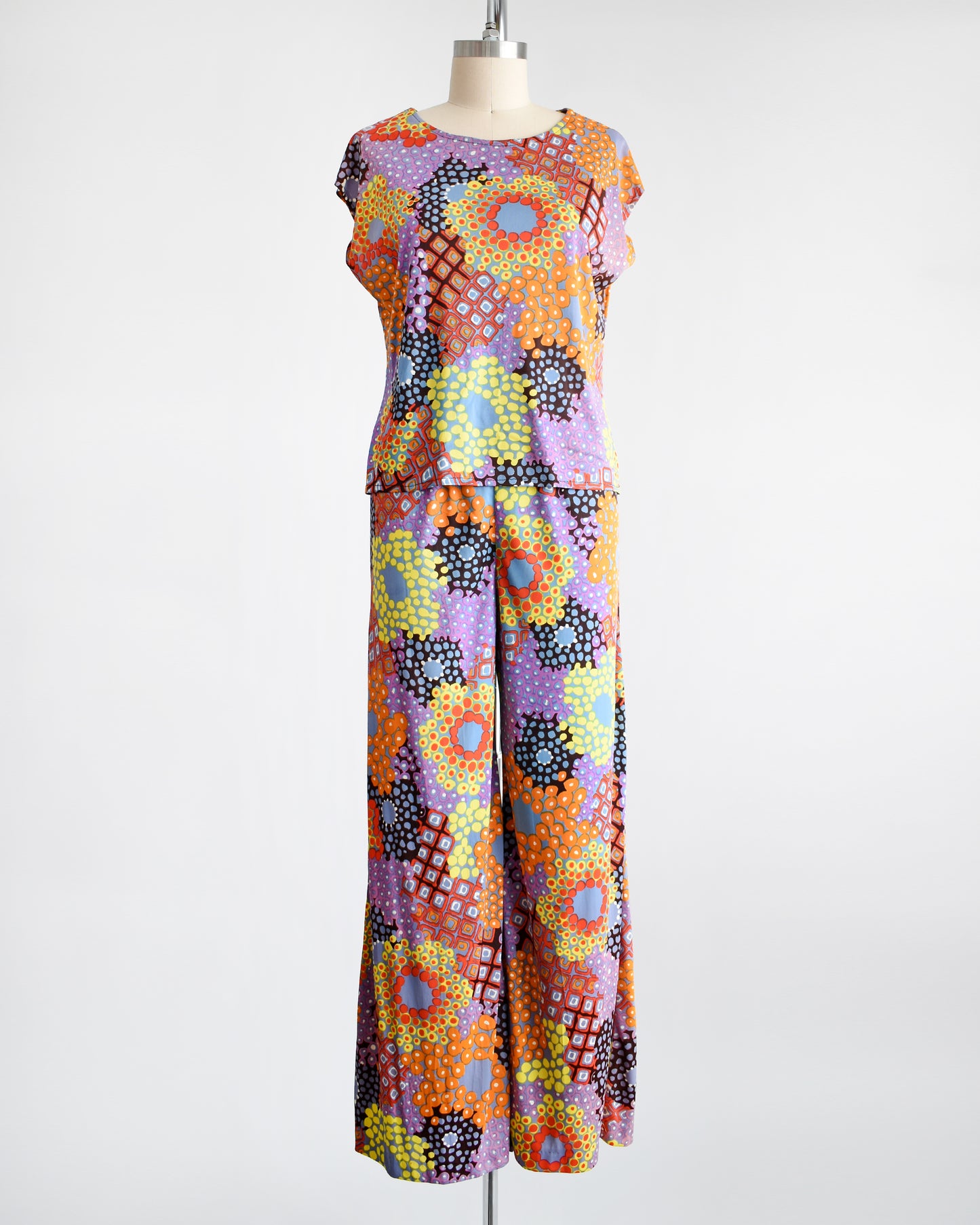 Vibrant vintage 1970 mod floral pantsuit that has a matching top and bottom