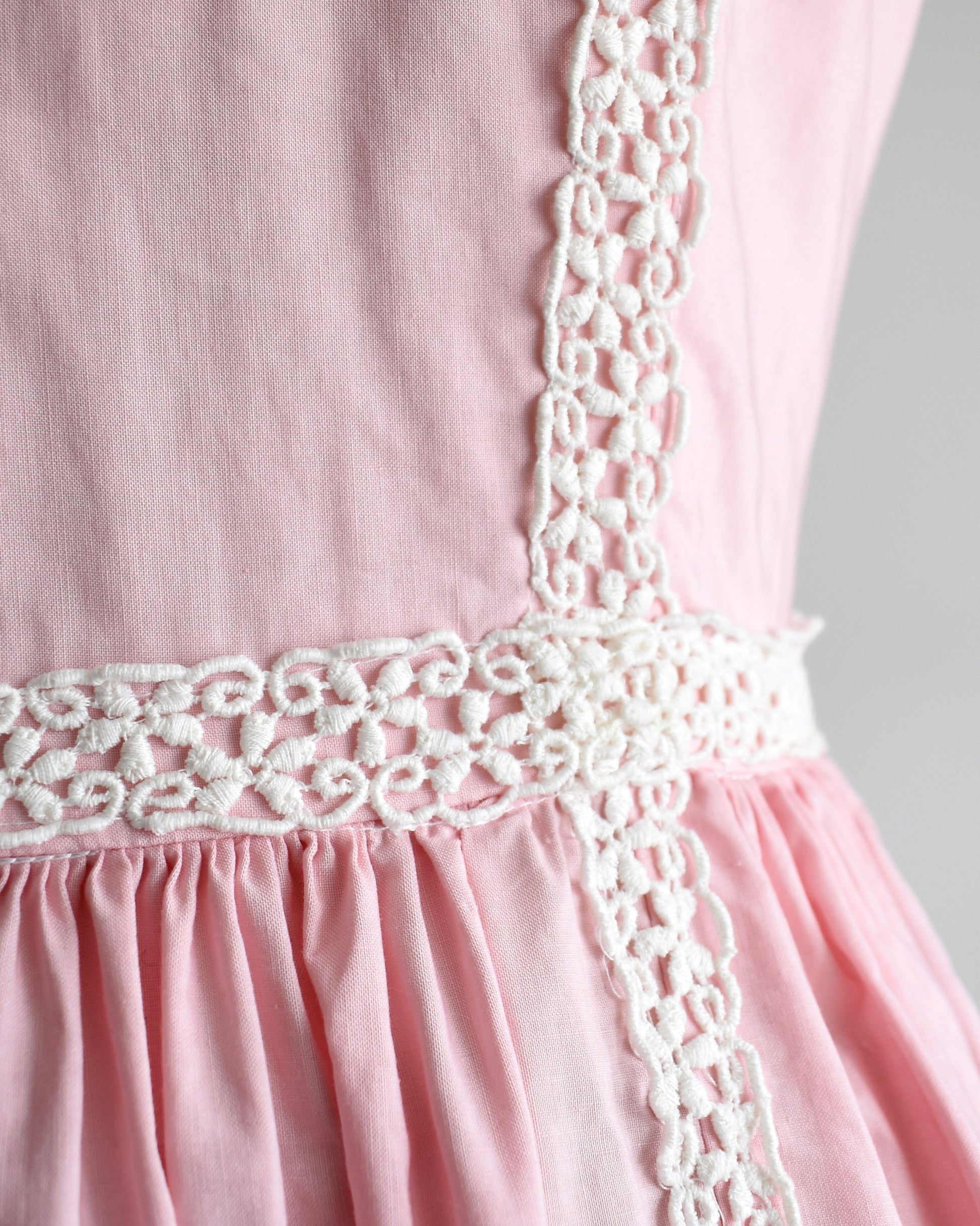 close up of the white floral lace on the dress