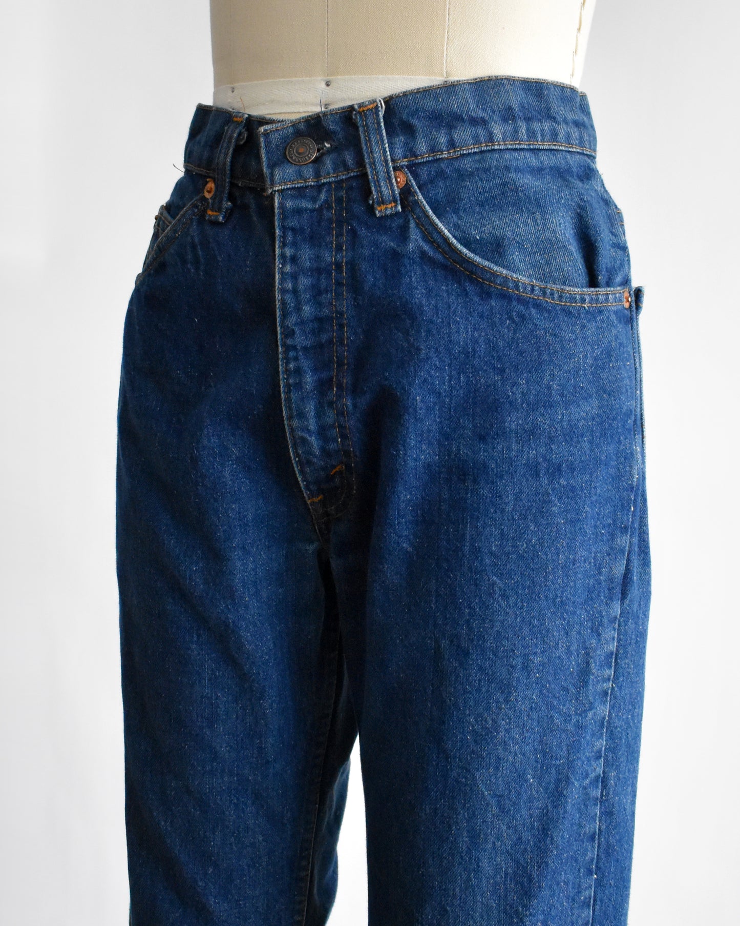 side front view of vintage 1980s orange tab book cut 517 Lev's on a mannequin on a dress form