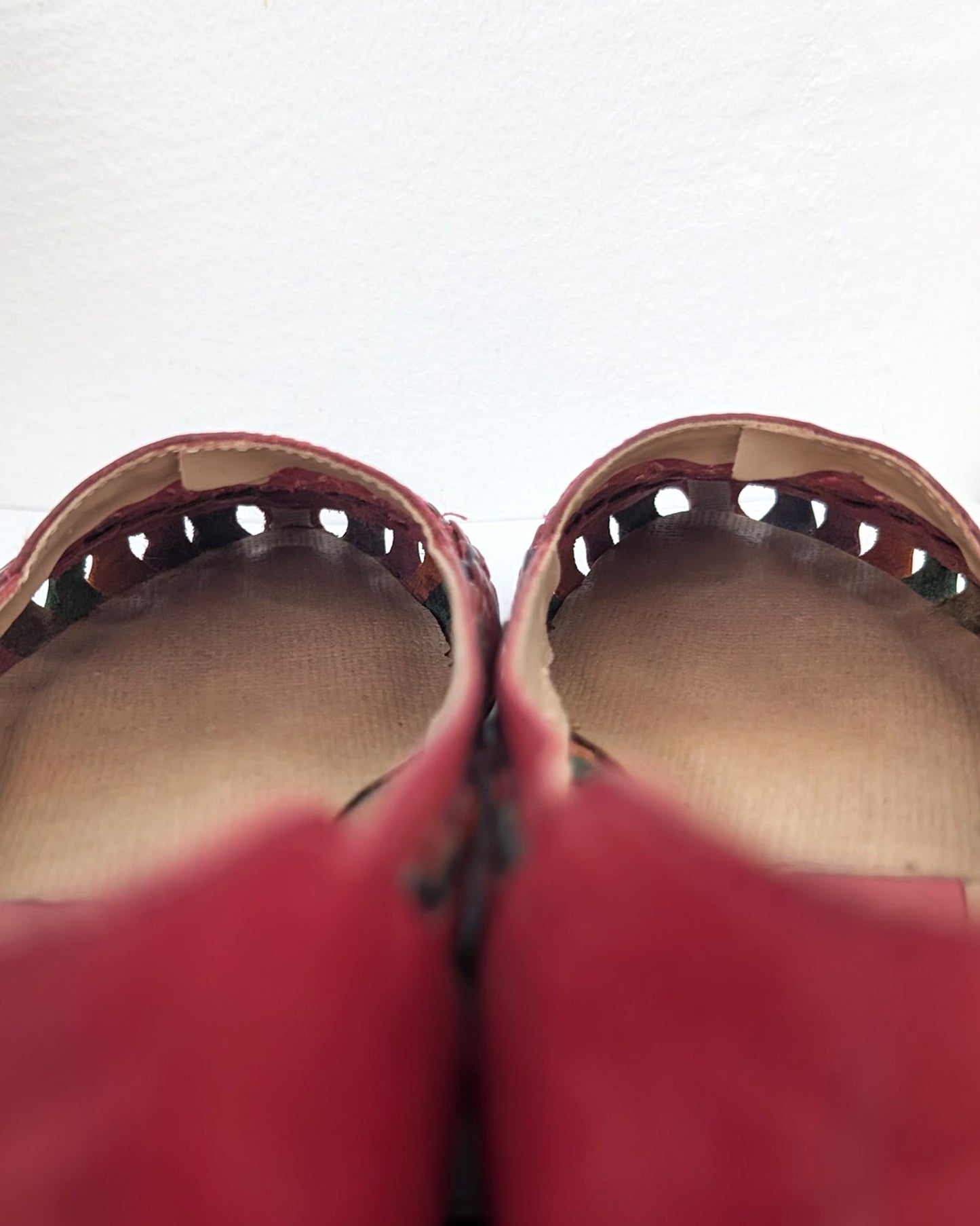 A close-up view of a pair of sandals showing the lining along the top of the shoe has an overlapping split int he material (this looks to be intentional and doesn't affect the wear of the shoe