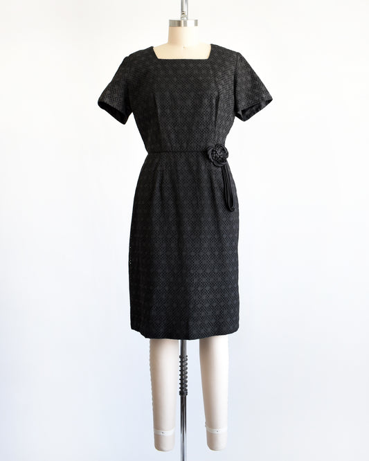 a vintage 1960s black eyelet dress on a mannequin on a dress form