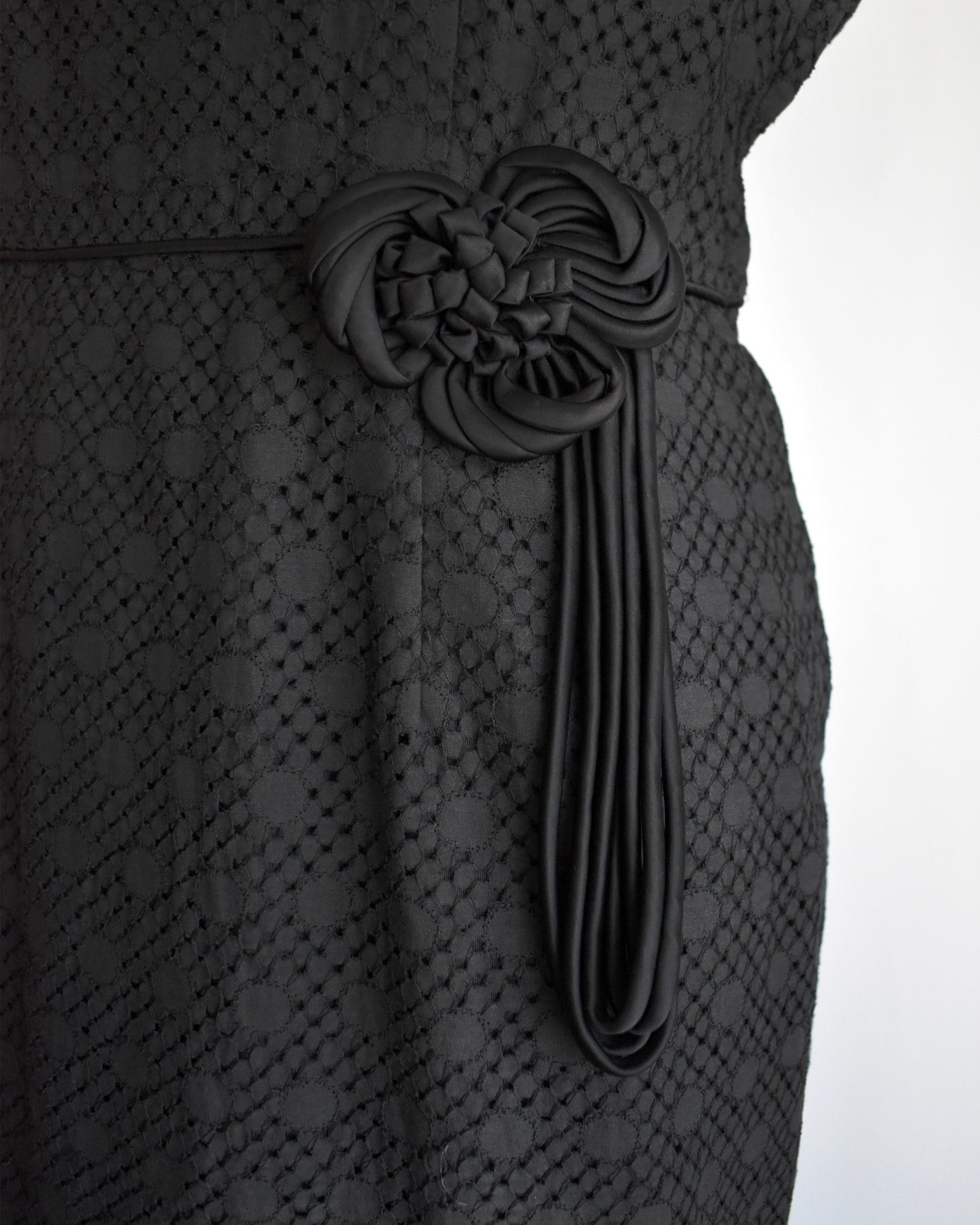 close up of the decorative ribbon on the waist of the dress