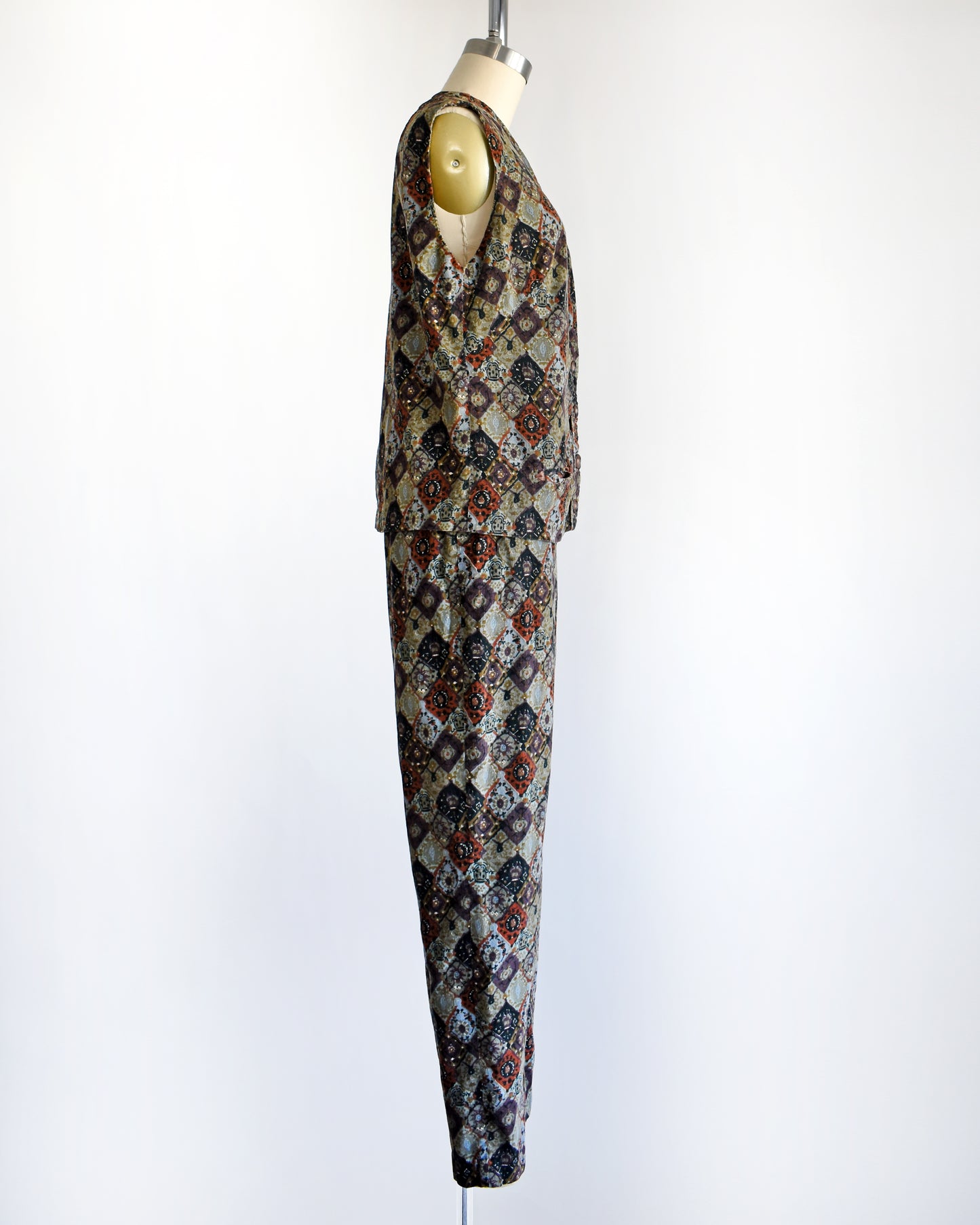 side view of a vintage 1960s floral patterned vest and pants set on a mannequin against a white background