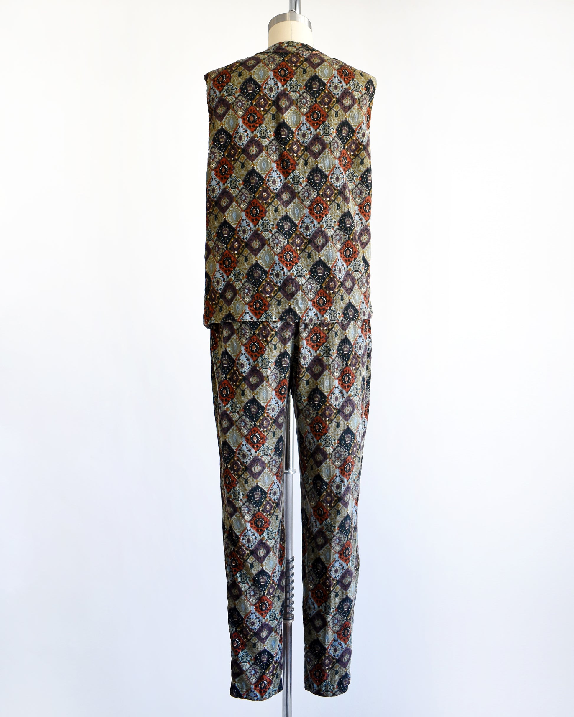 back view of a vintage 1960s floral patterned vest and pants set on a mannequin against a white background