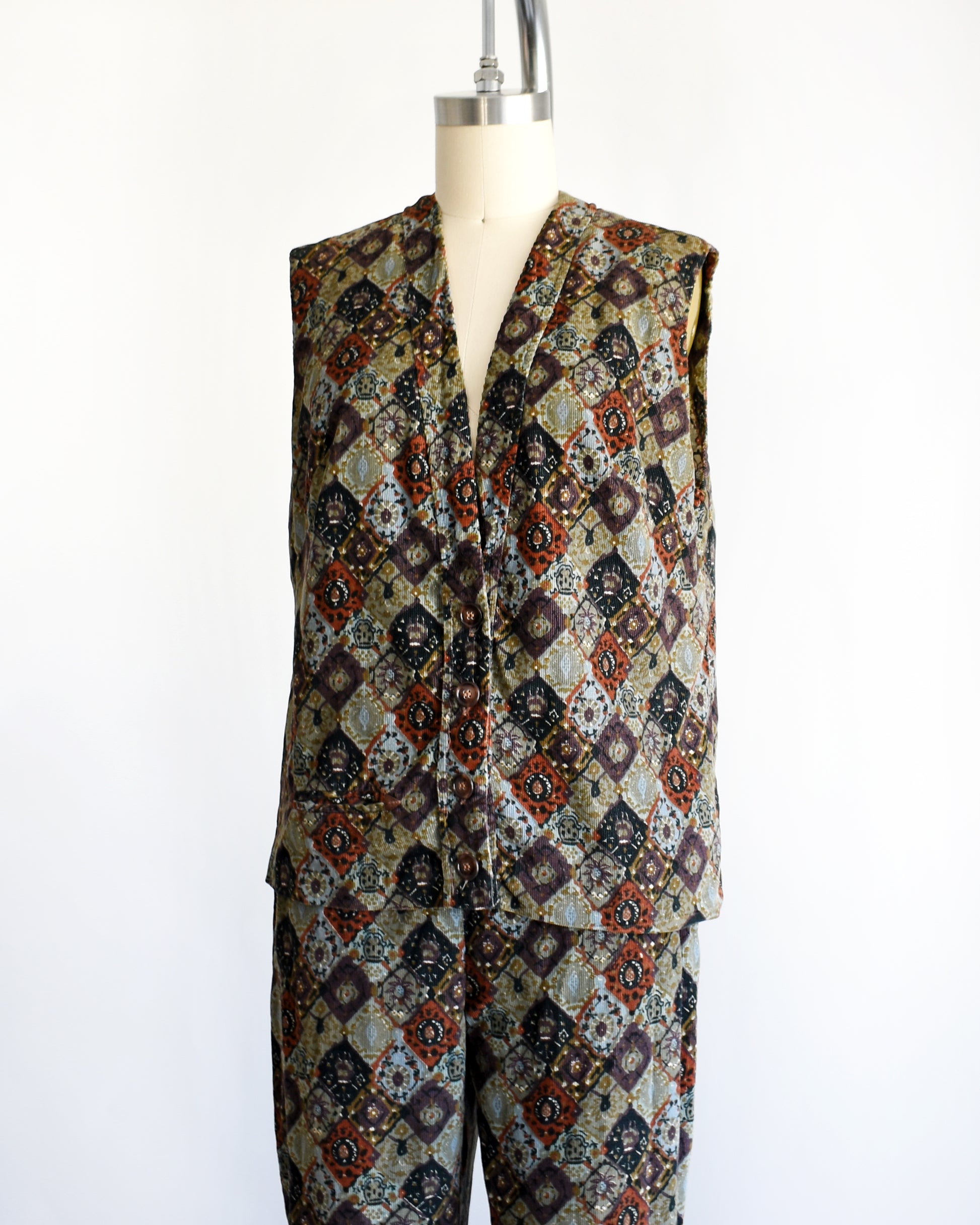 side front view of a vintage 1960s floral patterned vest and pants set on a mannequin against a white background