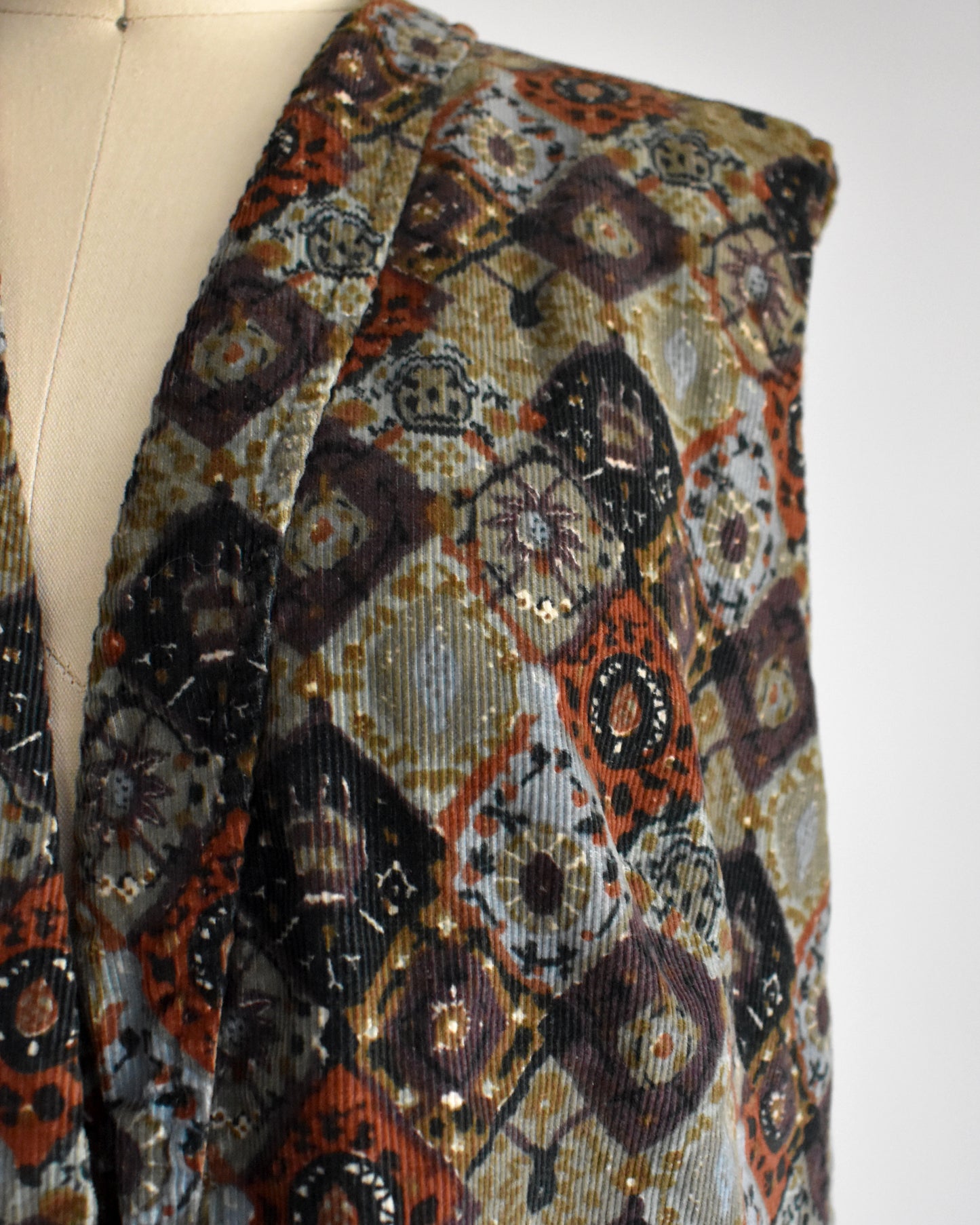 close up of the vest on a vintage 1960s floral patterned vest 