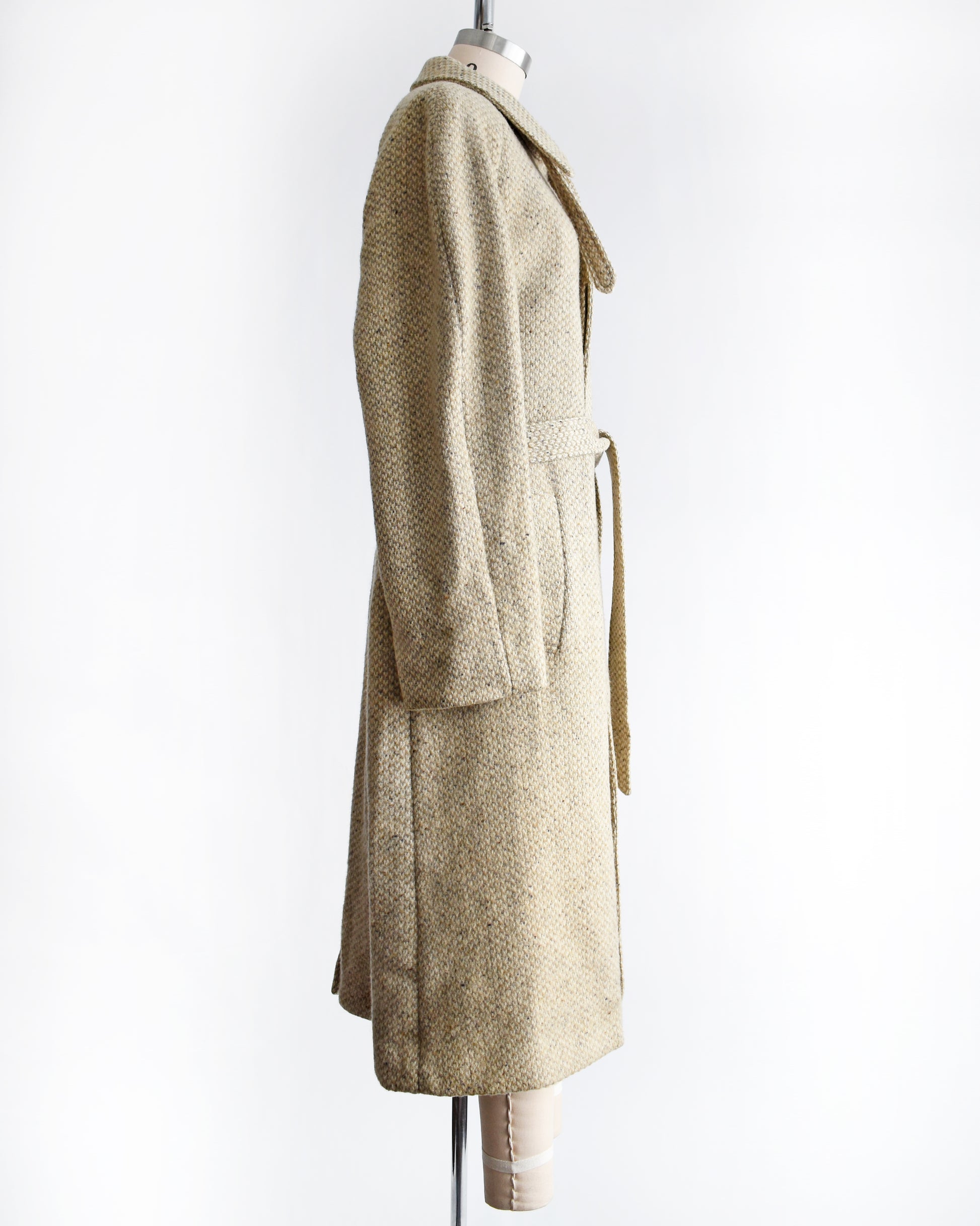side view of a vintage Pierre Cardin wool coat on a mannequin against a white background