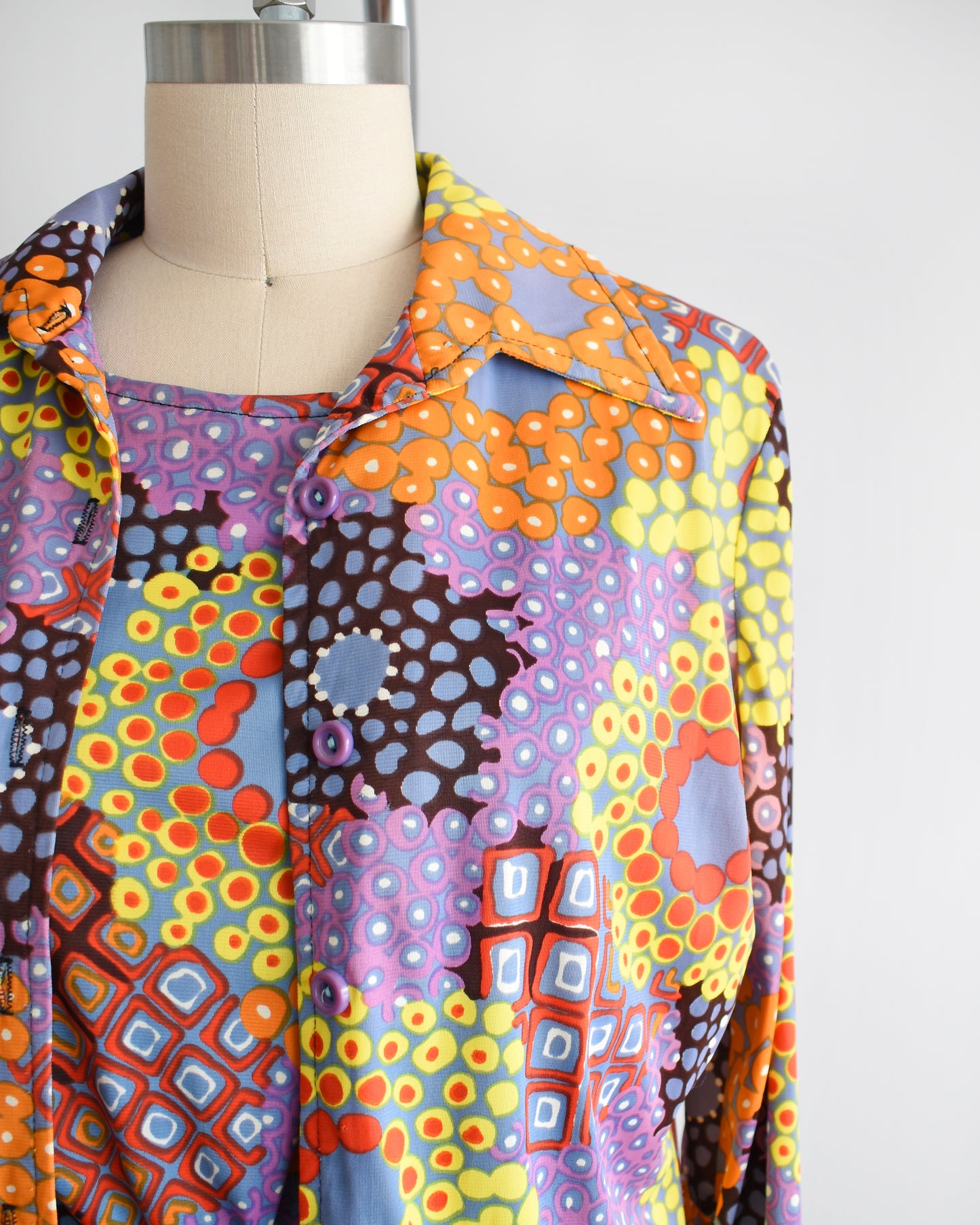 Close up of the vibrant mod print on the blouse and cap sleeve top