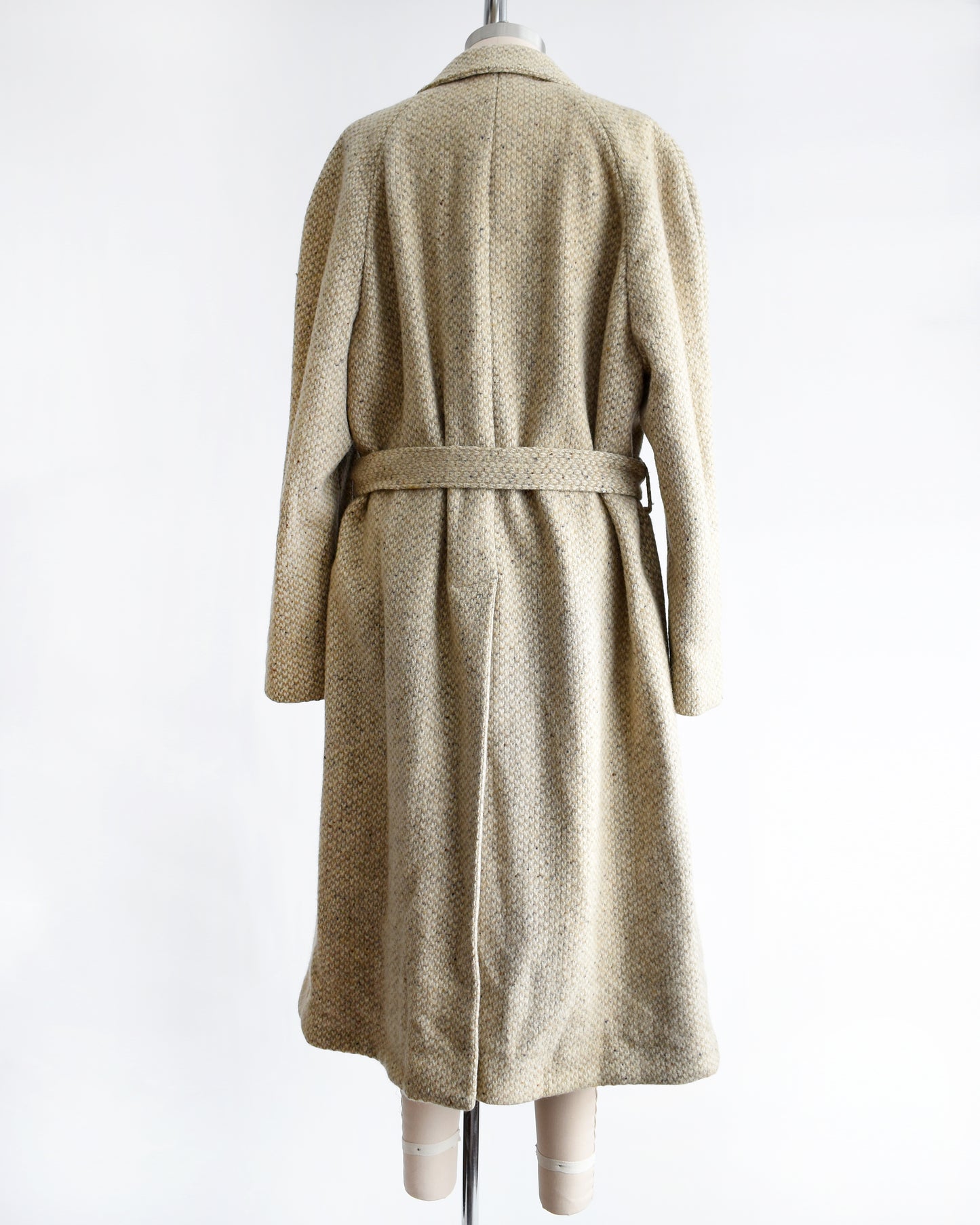 back view of a vintage Pierre Cardin wool coat on a mannequin against a white background
