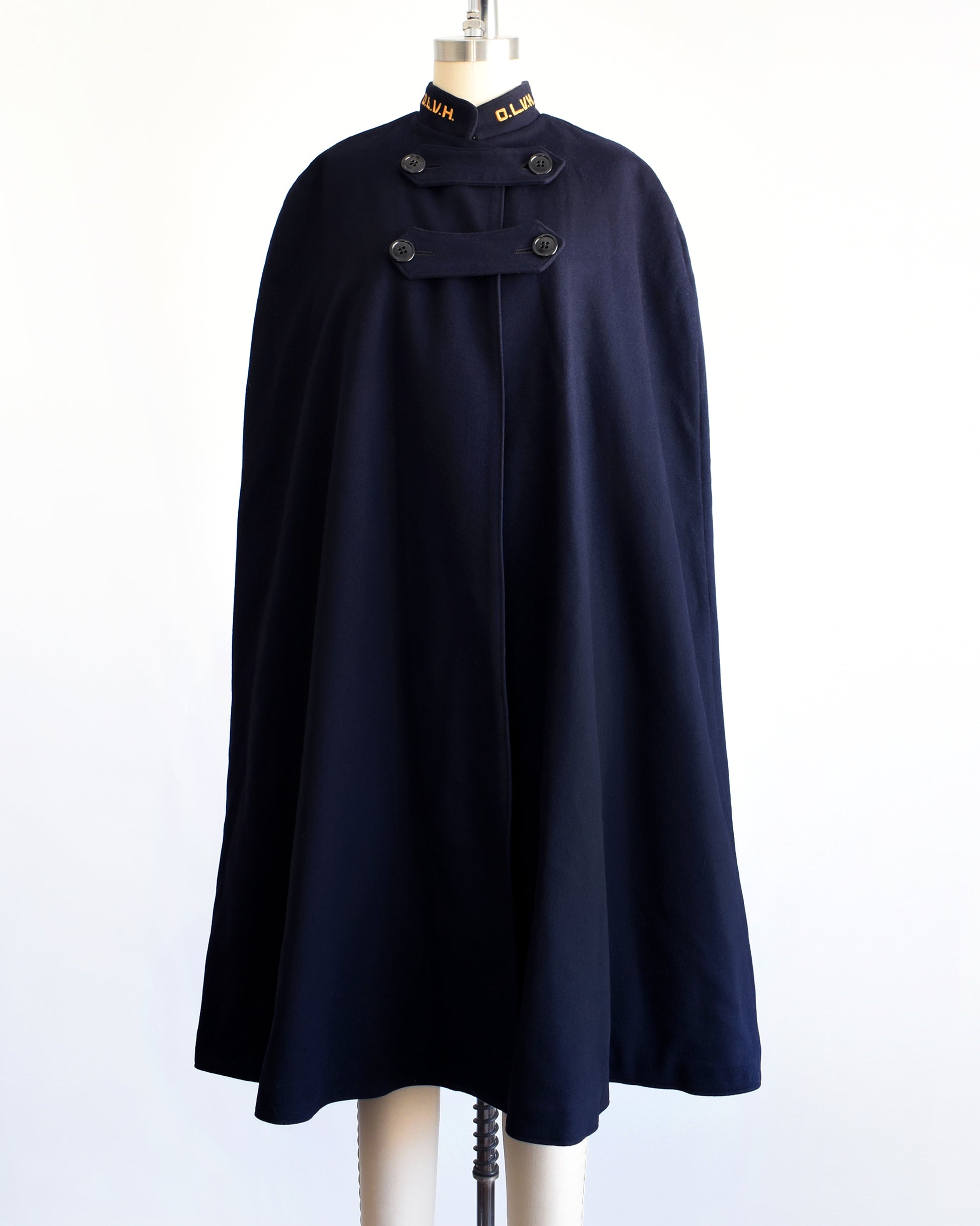 a vintage 1940s navy nurse's cape on a mannequin against a white background. 