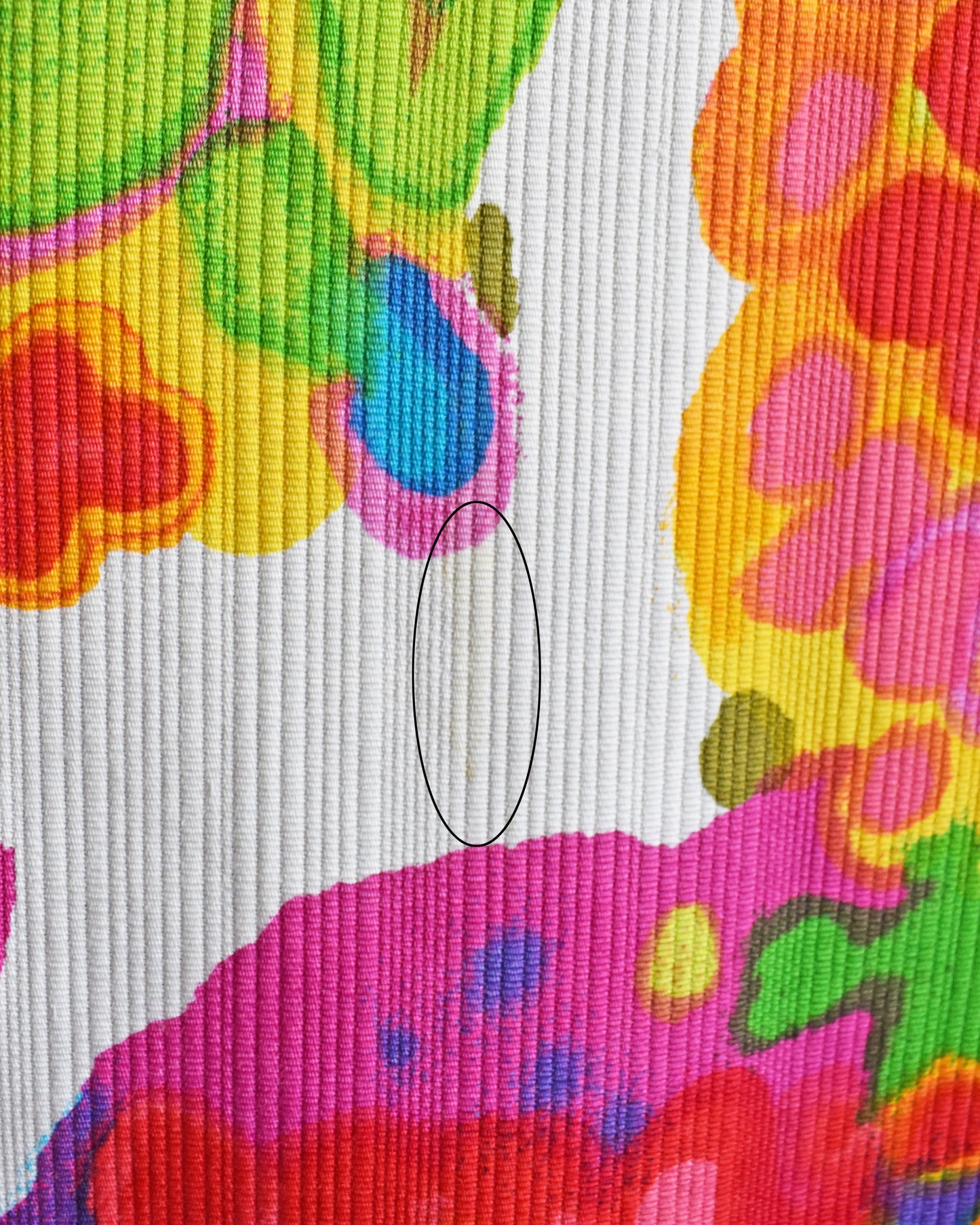 a circled close up of a small yellow spot flaw that didn't come out during cleaning