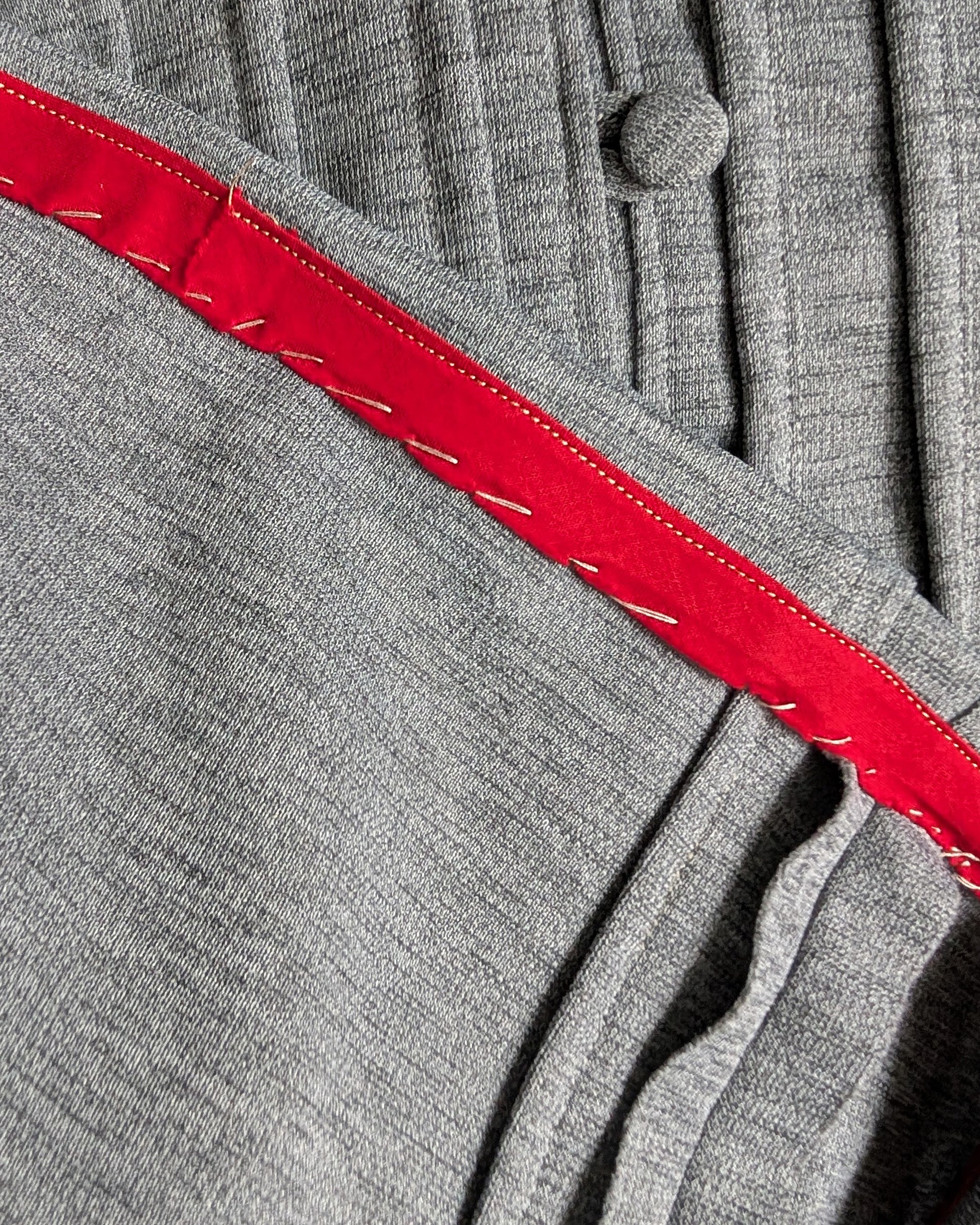 the underside of the dress hem showing the red bias tape