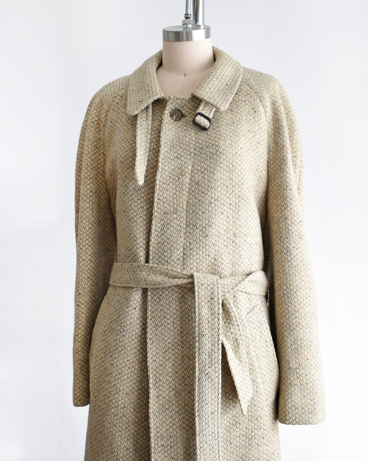 side front view of a vintage Pierre Cardin wool coat on a mannequin against a white background
