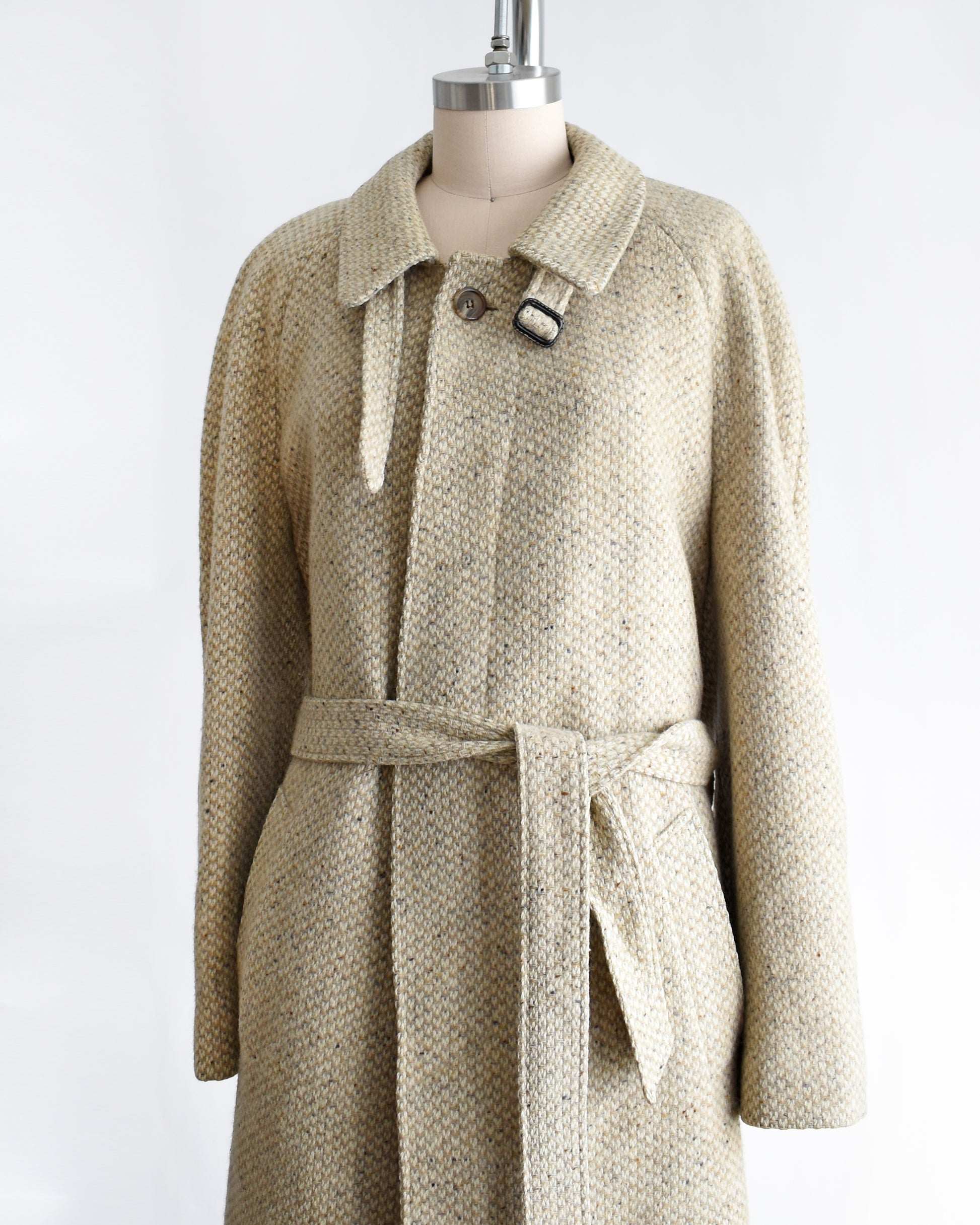 side front view of a vintage Pierre Cardin wool coat on a mannequin against a white background