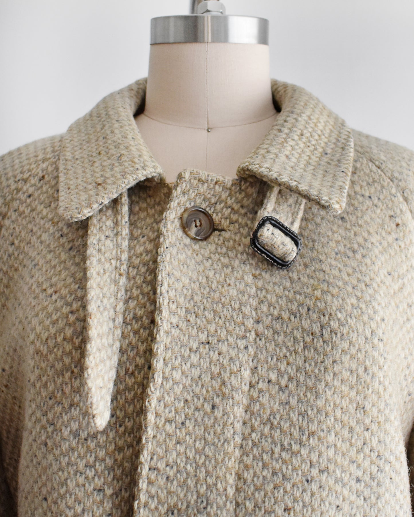 close up of the collar of a vintage Pierre Cardin wool coat on a mannequin against a white background