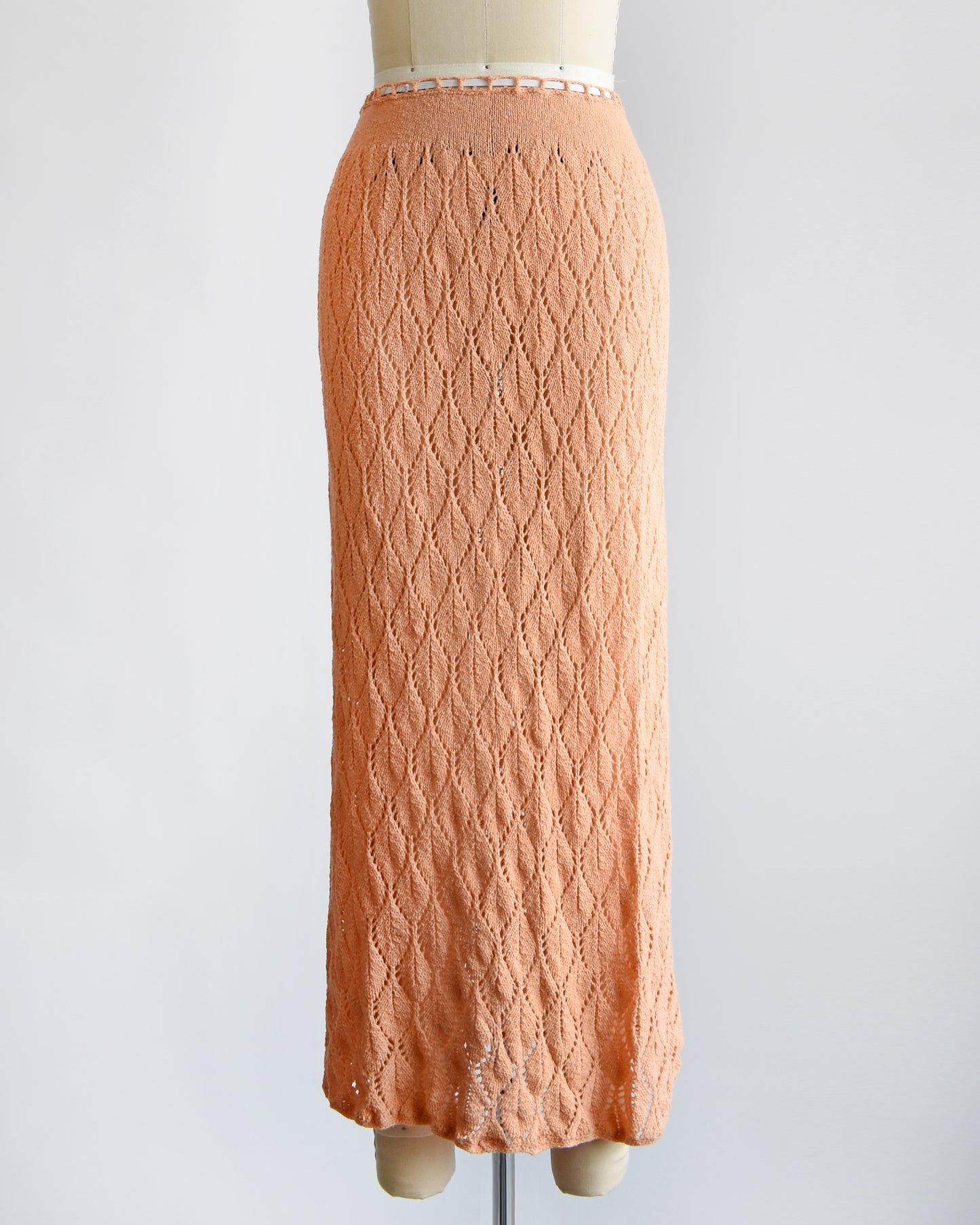 a vintage 60s peach pointelle knit maxi sweater skirt.