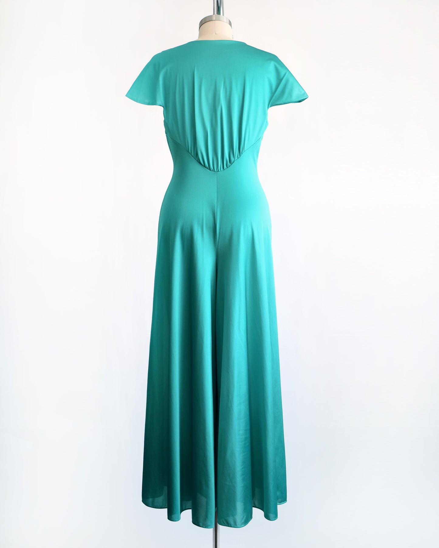 back view of a vintage 1970s teal palazzo jumpsuit by Vanity Fair