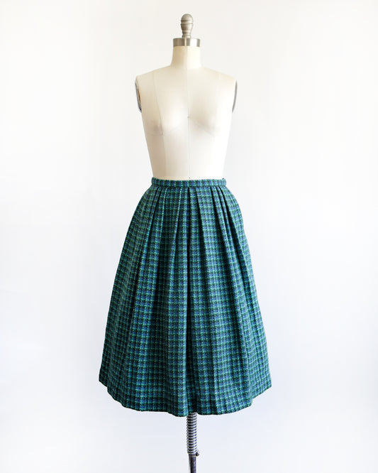 a vintage 1950s/1960s blue and green plaid skirt on a mannequin against a white background