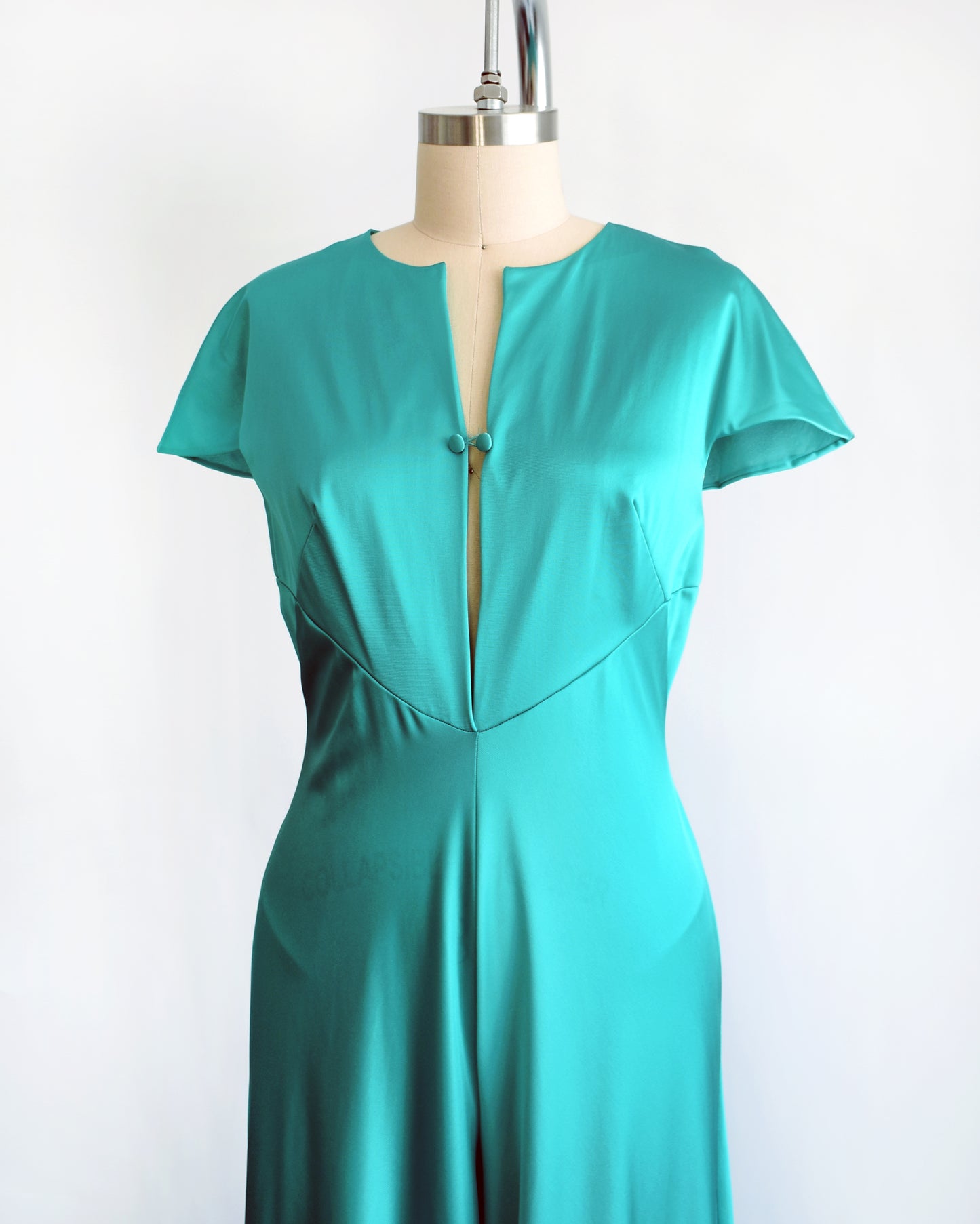 side front view of a vintage 1970s teal palazzo jumpsuit by Vanity Fair