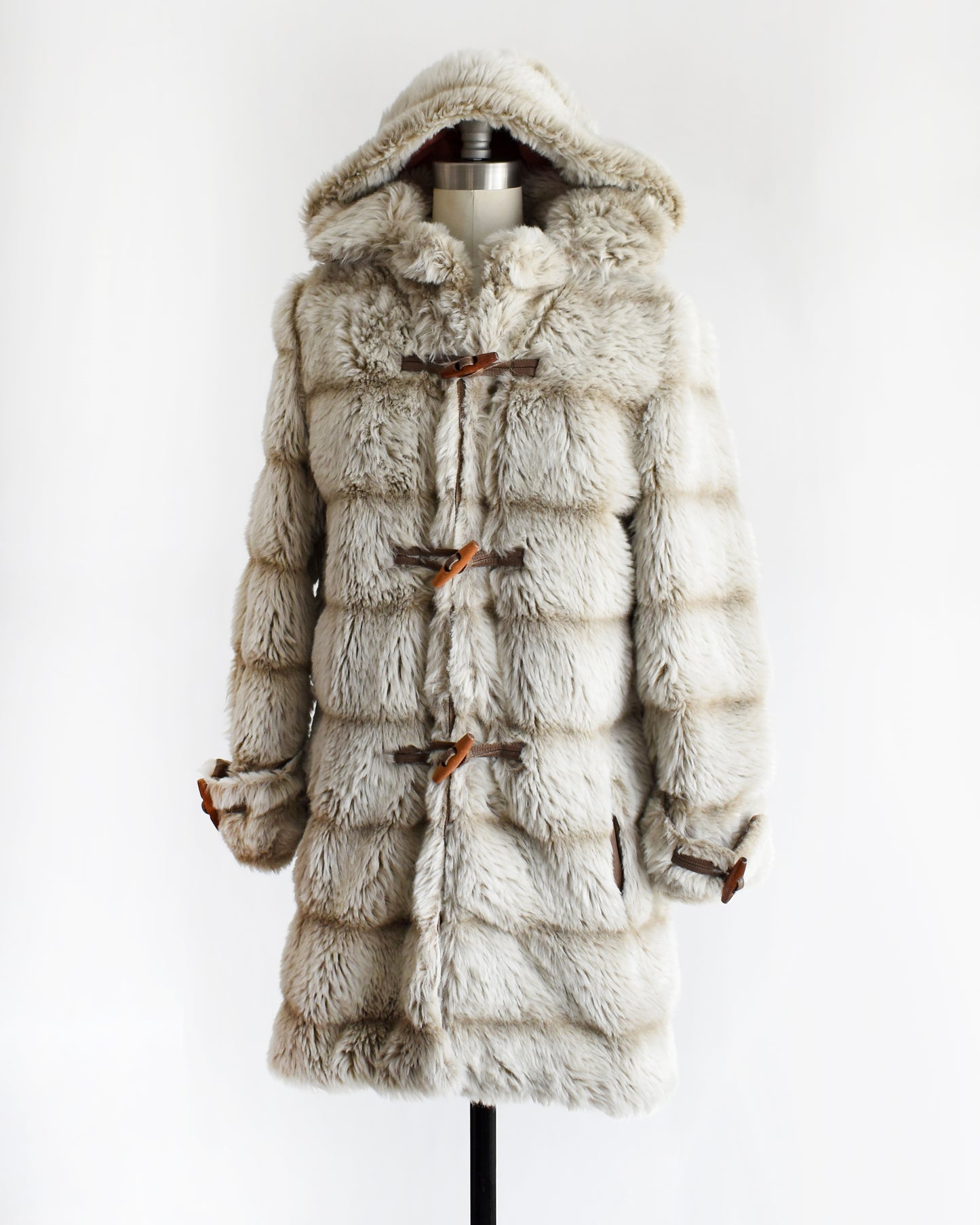 side front view of a vintage 1970s faux fur coat with hood on a mannequin against a white background