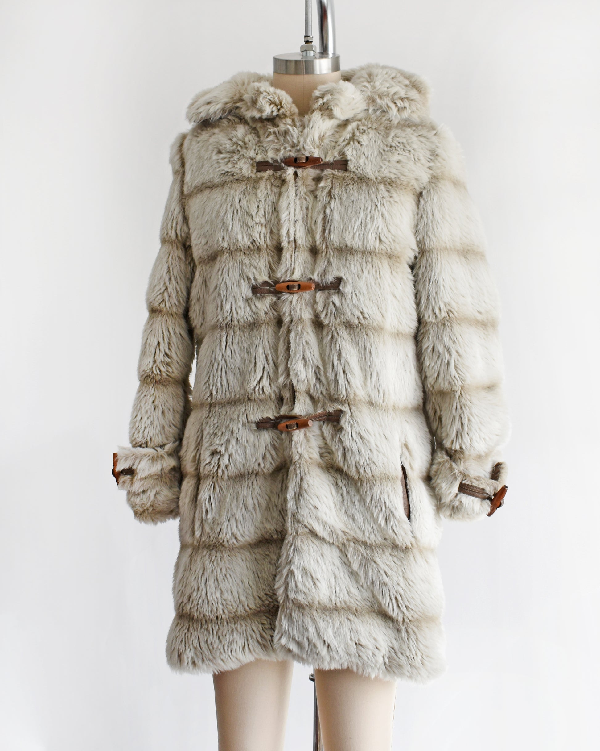 side front view a vintage 1970s faux fur coat with hood on a mannequin against a white background