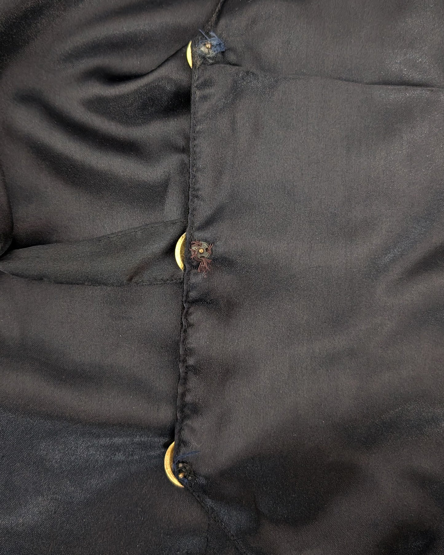Close-up of the inside of the vest showing the button details