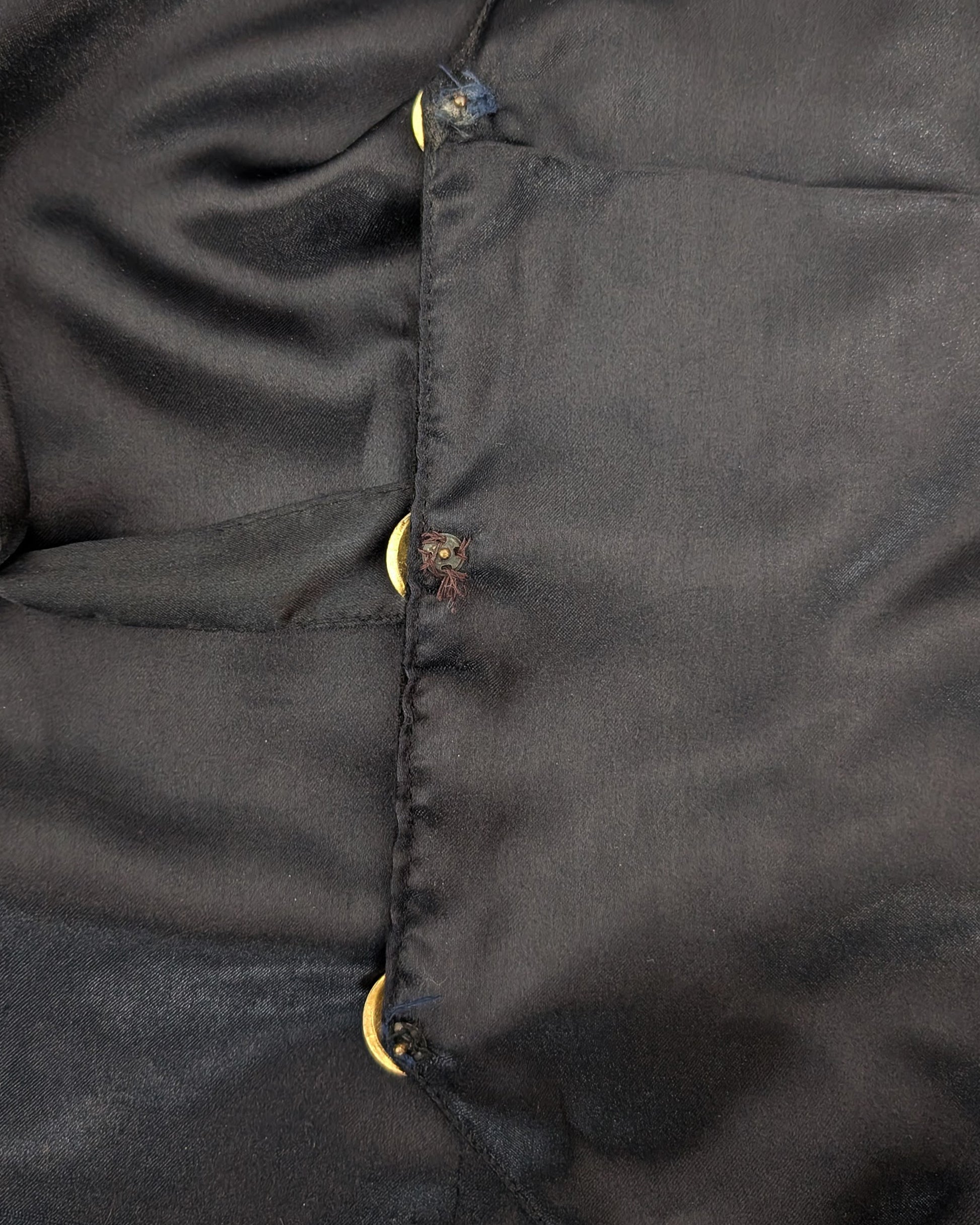 Close-up of the inside of the vest showing the button details