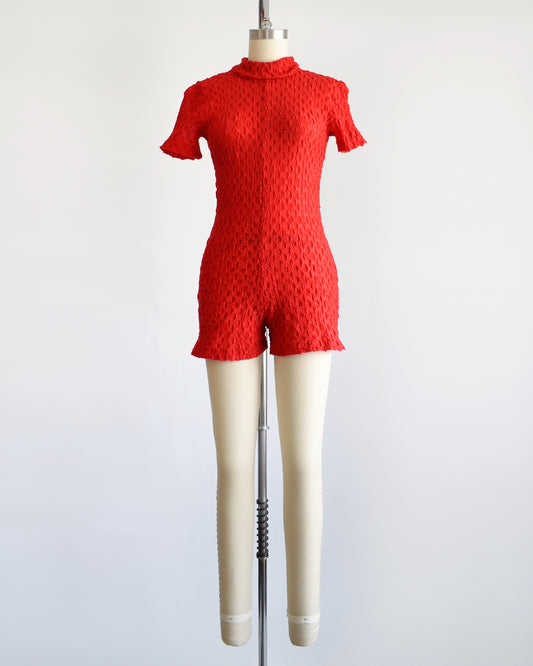 a vintage late 60s early 70s red textured knit bodysuit/romper