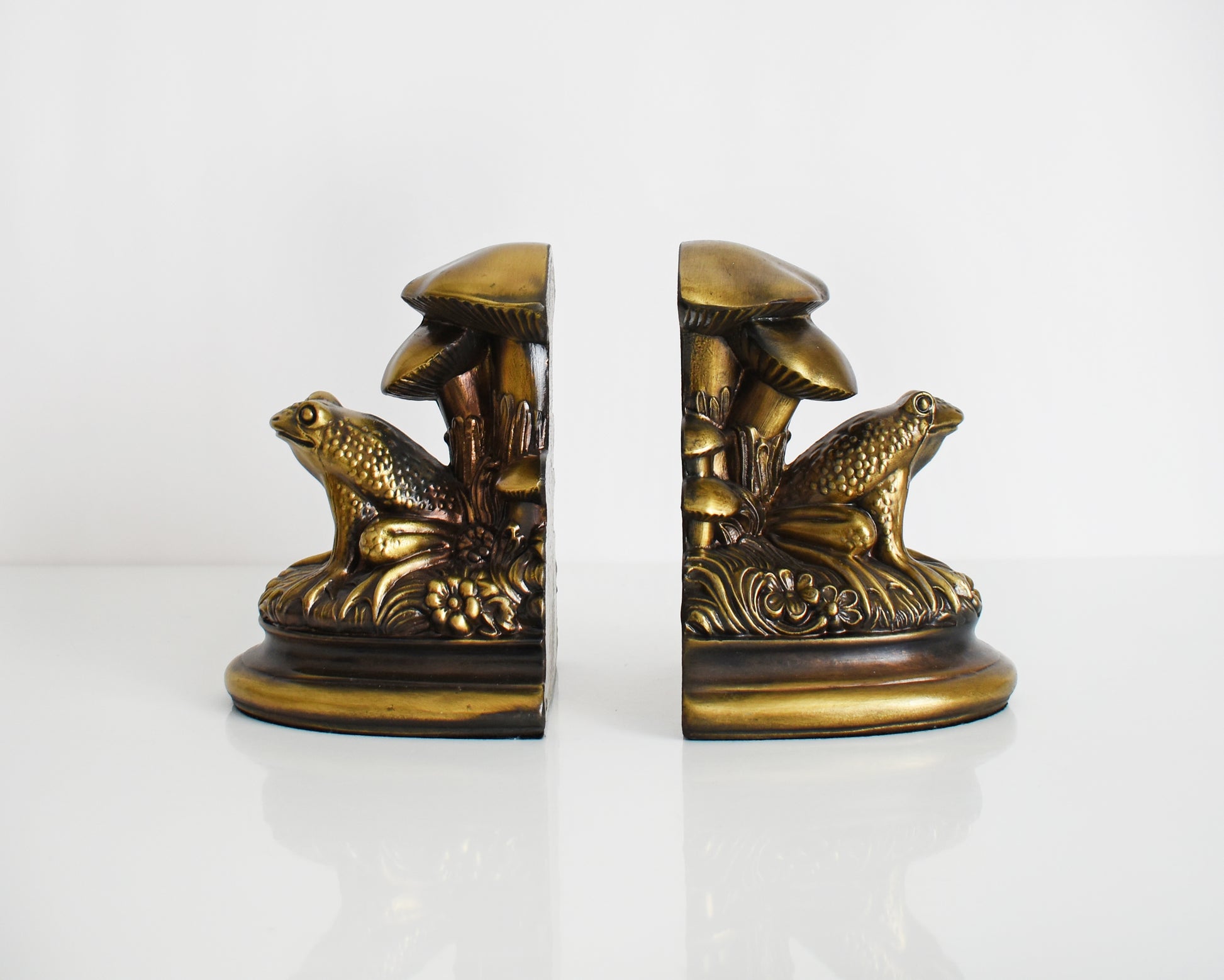 Side view of  vintage brass frog and mushroom bookends