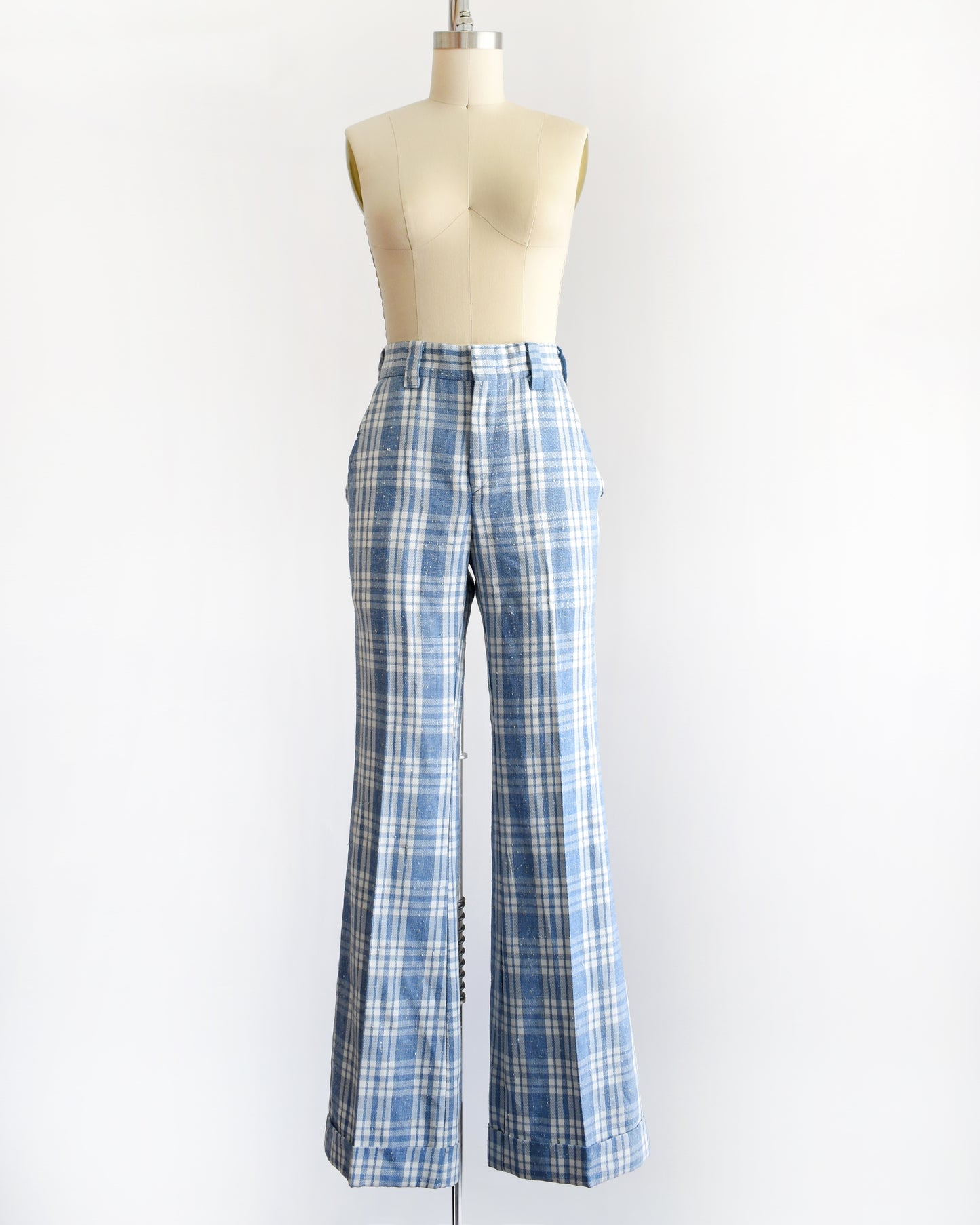 vintage 1970s blue and white plaid wide-leg pants displayed on a cream dress form mannequin against a plain white background.