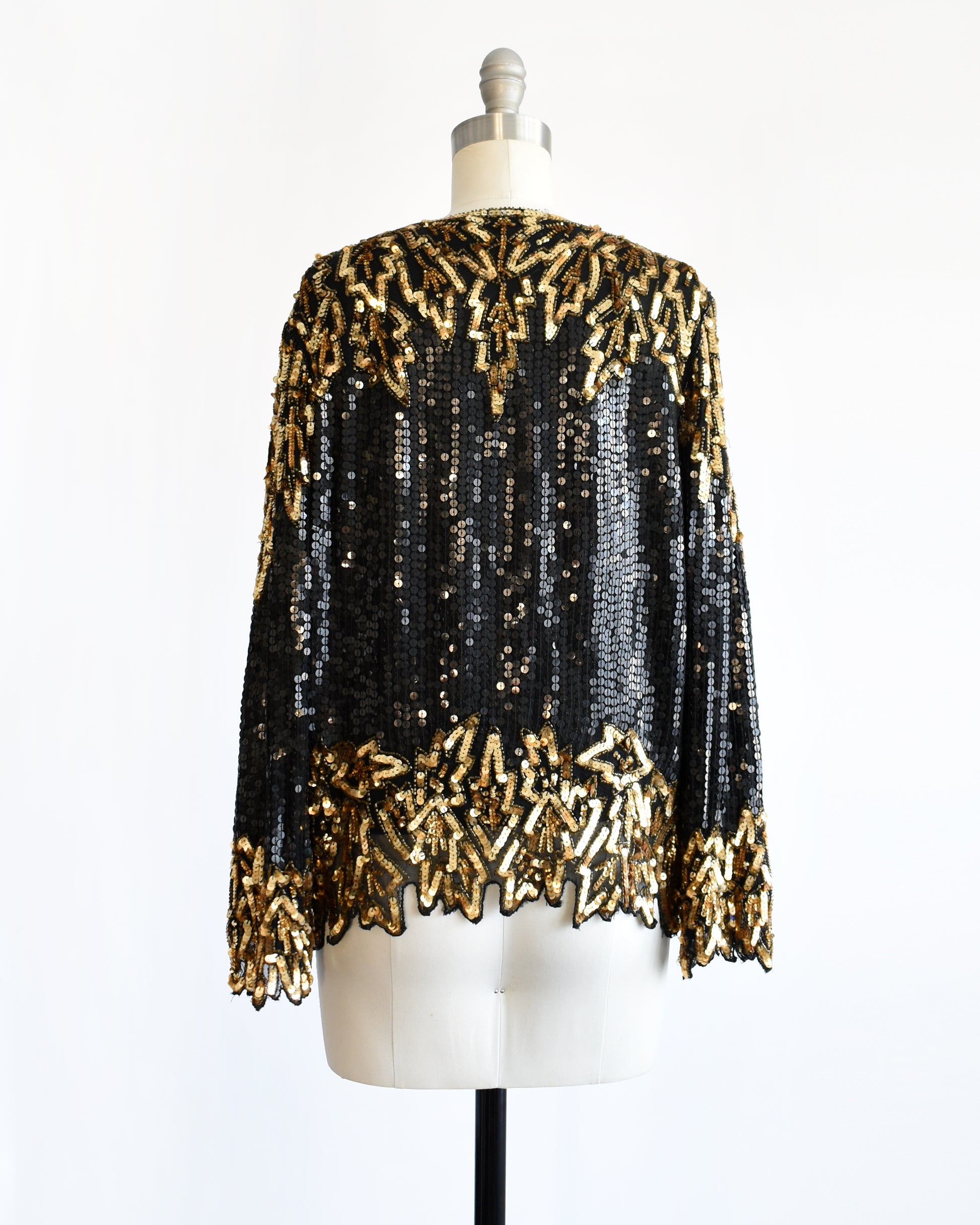 back view of a vintage 1980s black and gold sequin top on a mannequin against a white background